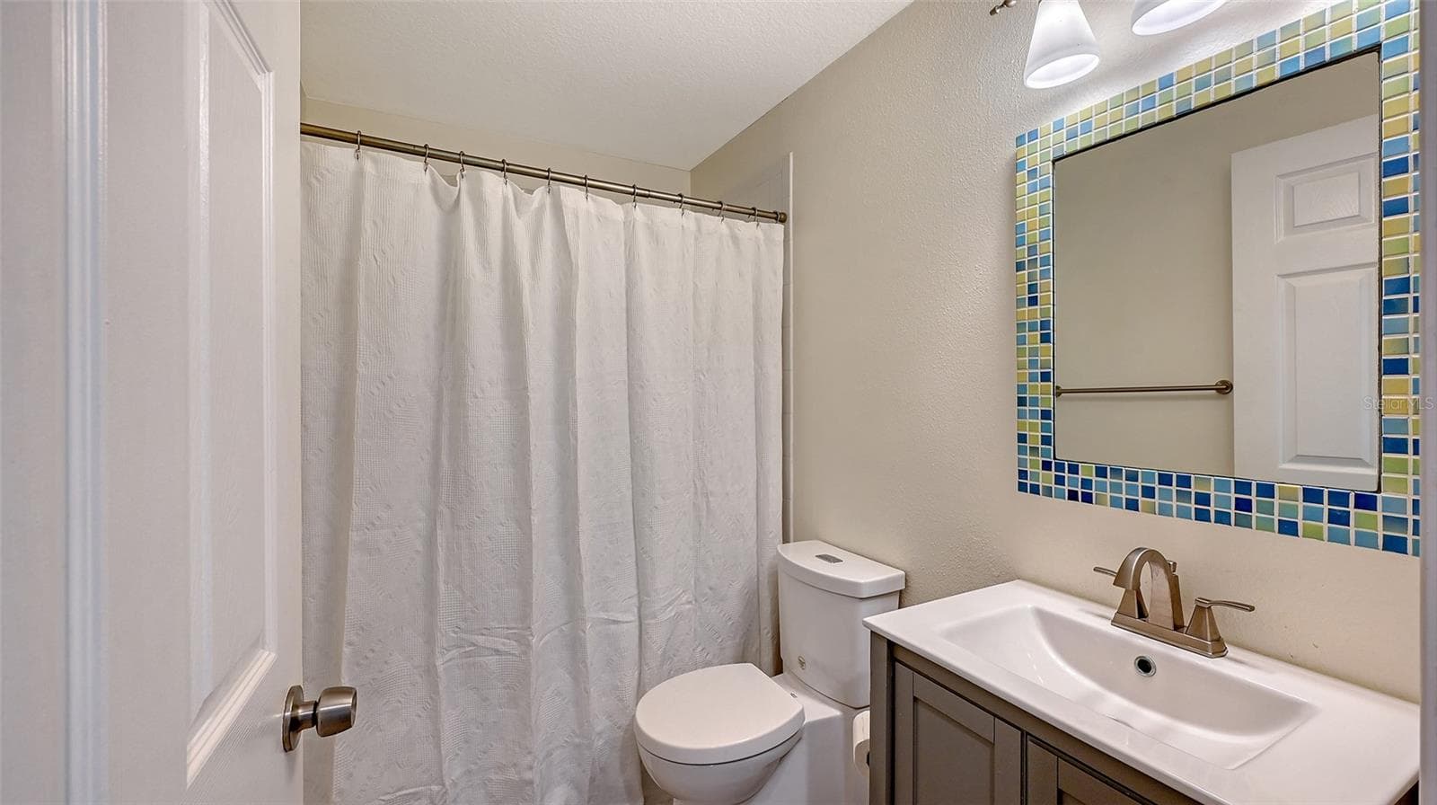 Well-appointed full bathroom features a stylish vanity, quality finishes, and a clean, sophisticated design. - 1685 6TH ST, SARASOTA