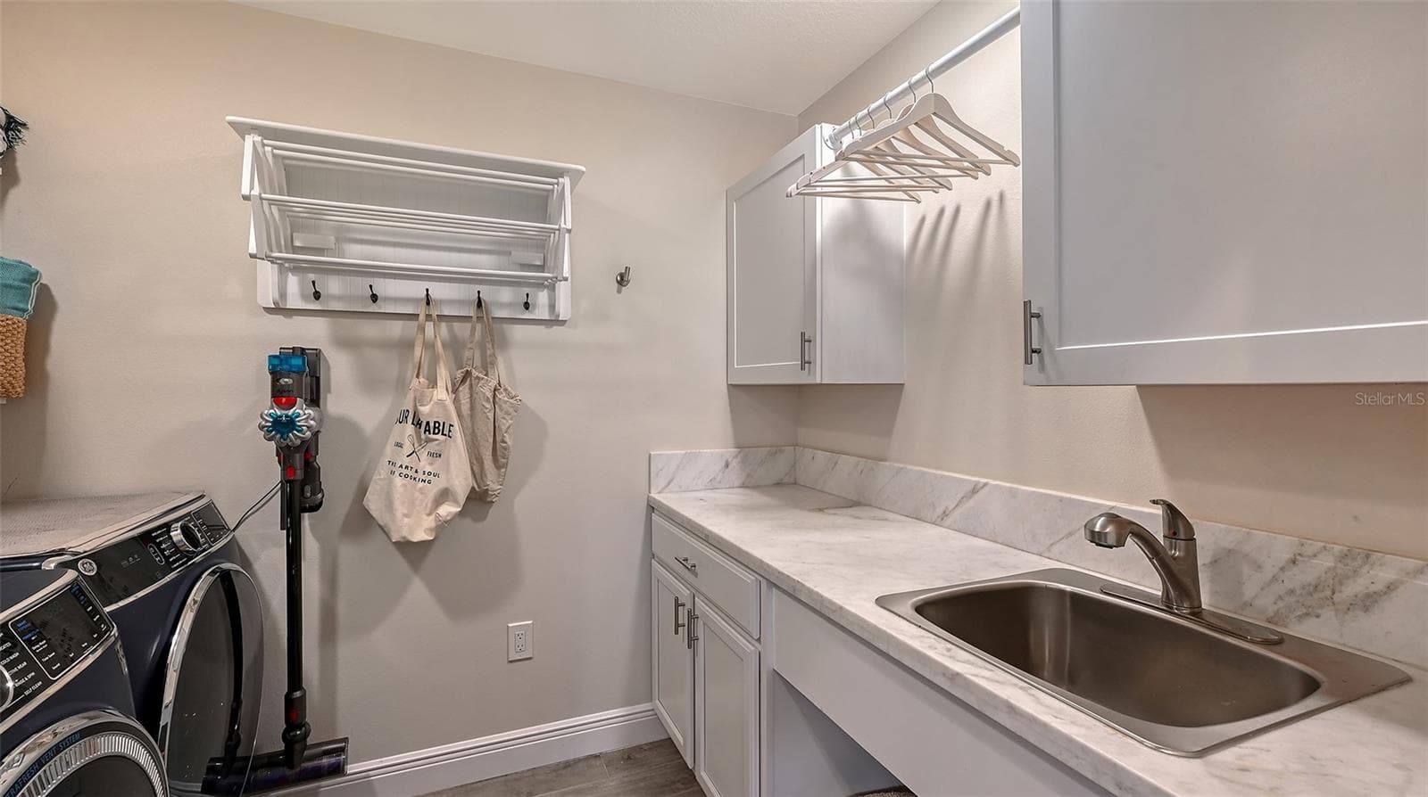 Dedicated laundry room provides exceptional functionality with generous cabinetry, folding space, and premium convenience. - 1685 6TH ST, SARASOTA