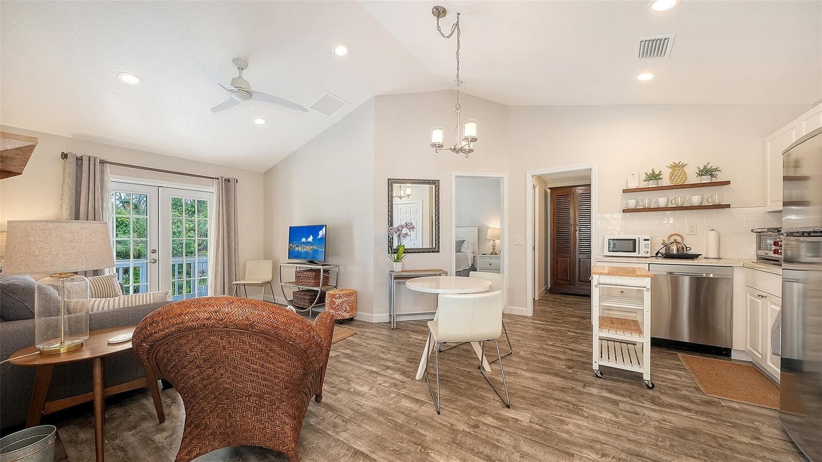 The Pineapple Loft offers a beautifully appointed open-concept living and dining area within the private guest apartment. - 1685 6TH ST, SARASOTA