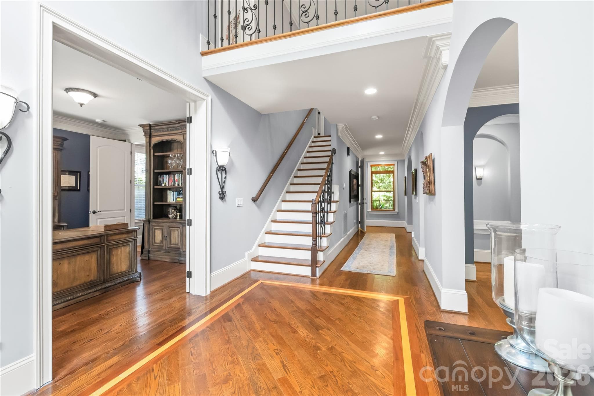 Flanked by a light-filled executive office on the left and an elegant formal dining room on the right, the main foyer makes an unforgettable first impression. - 7320 Summerlin Place, Charlotte