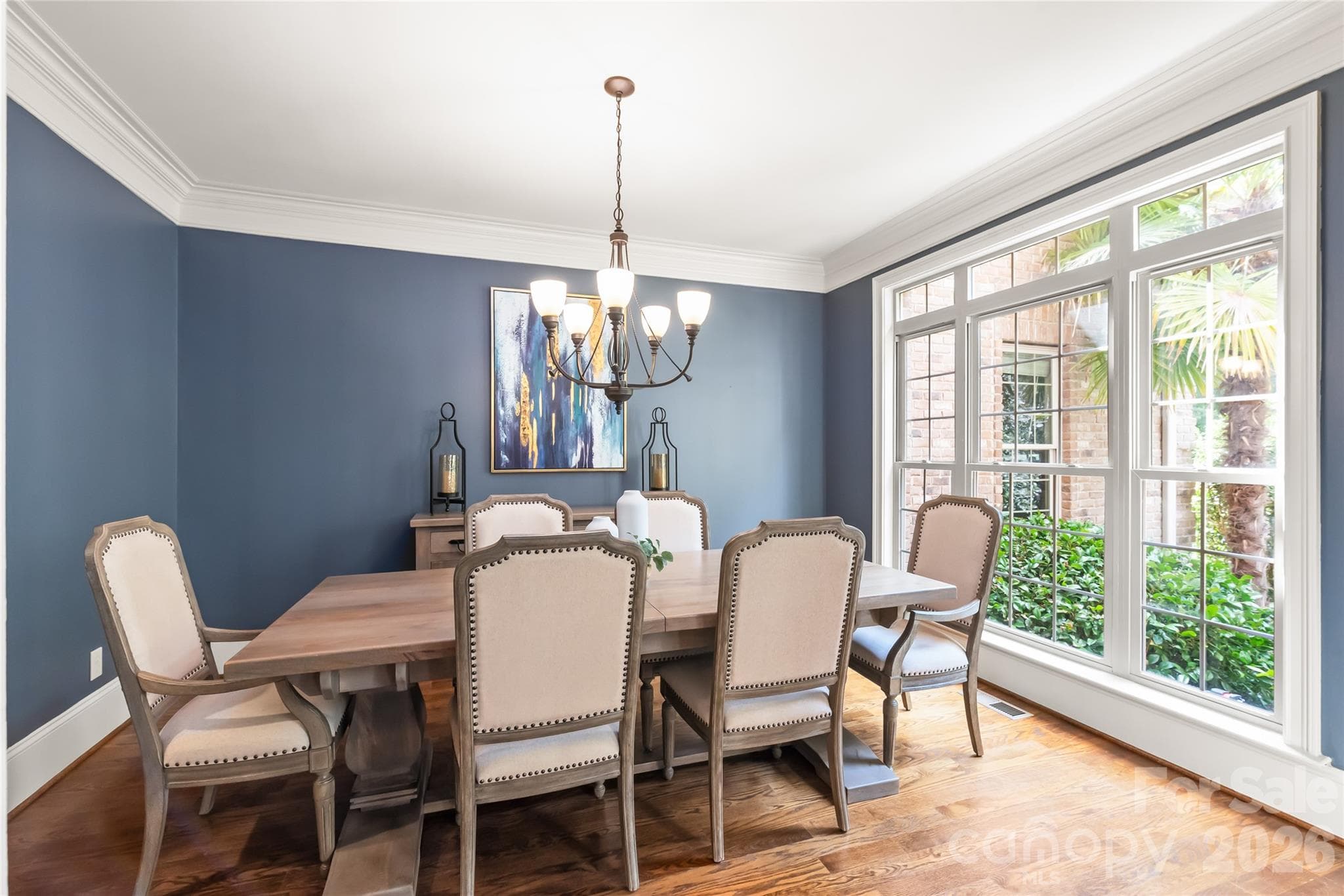 Large windows flood the formal dining room with natural light, creating an inviting space for gatherings. - 7320 Summerlin Place, Charlotte