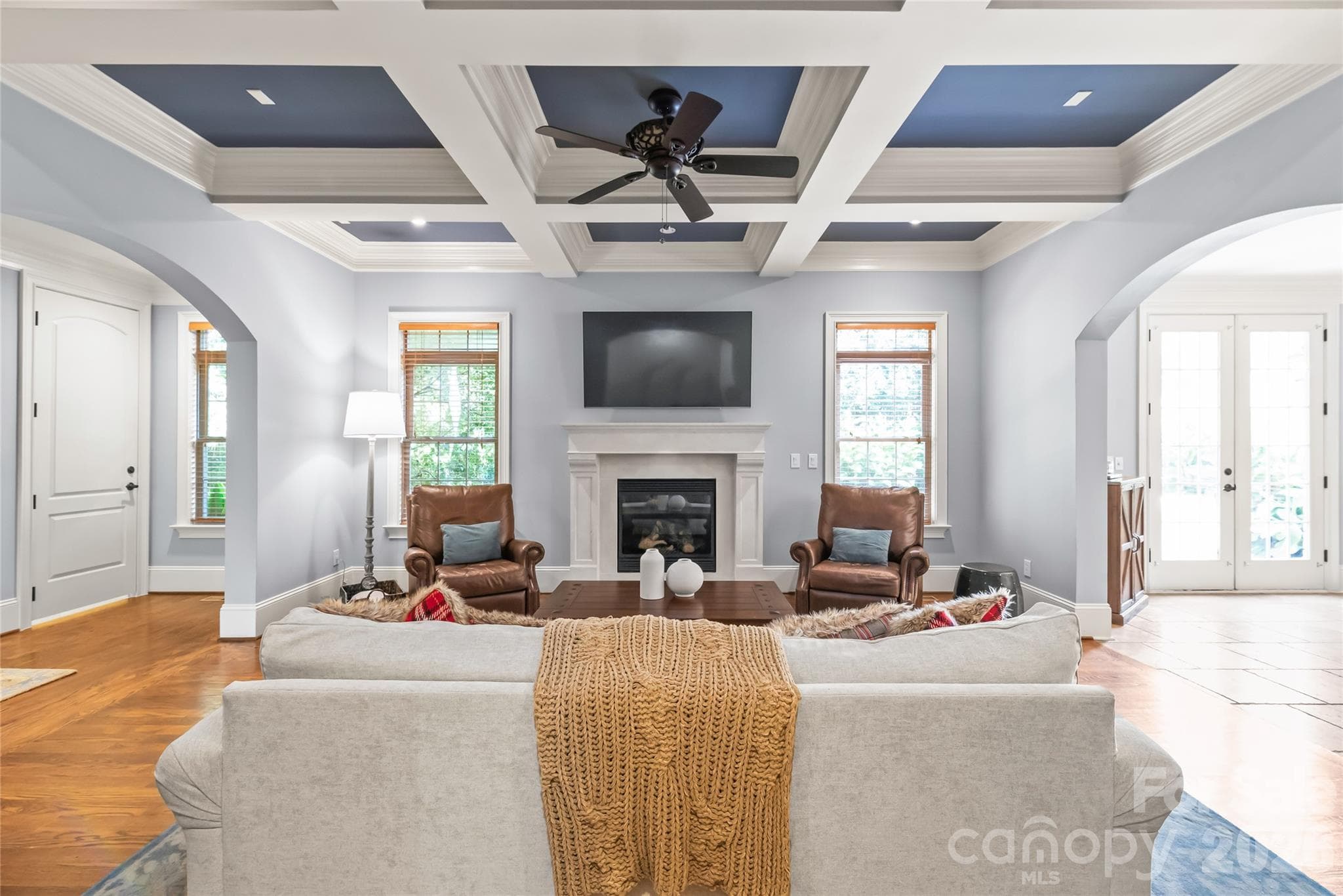 A stunning stone fireplace anchors the room, bringing natural texture and effortless warmth to the living space. - 7320 Summerlin Place, Charlotte