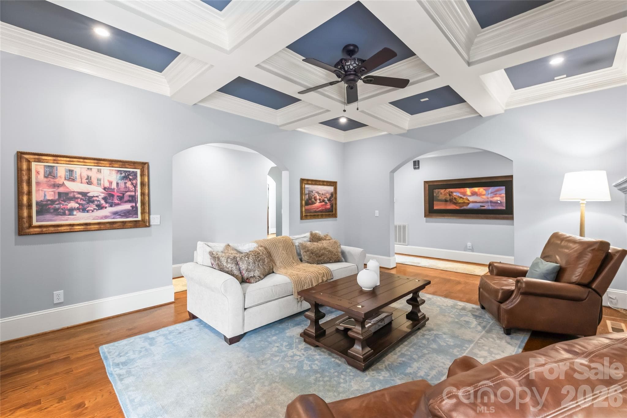 Architectural archways frame the layout with elegance, creating a seamless and sophisticated transition between living spaces. - 7320 Summerlin Place, Charlotte