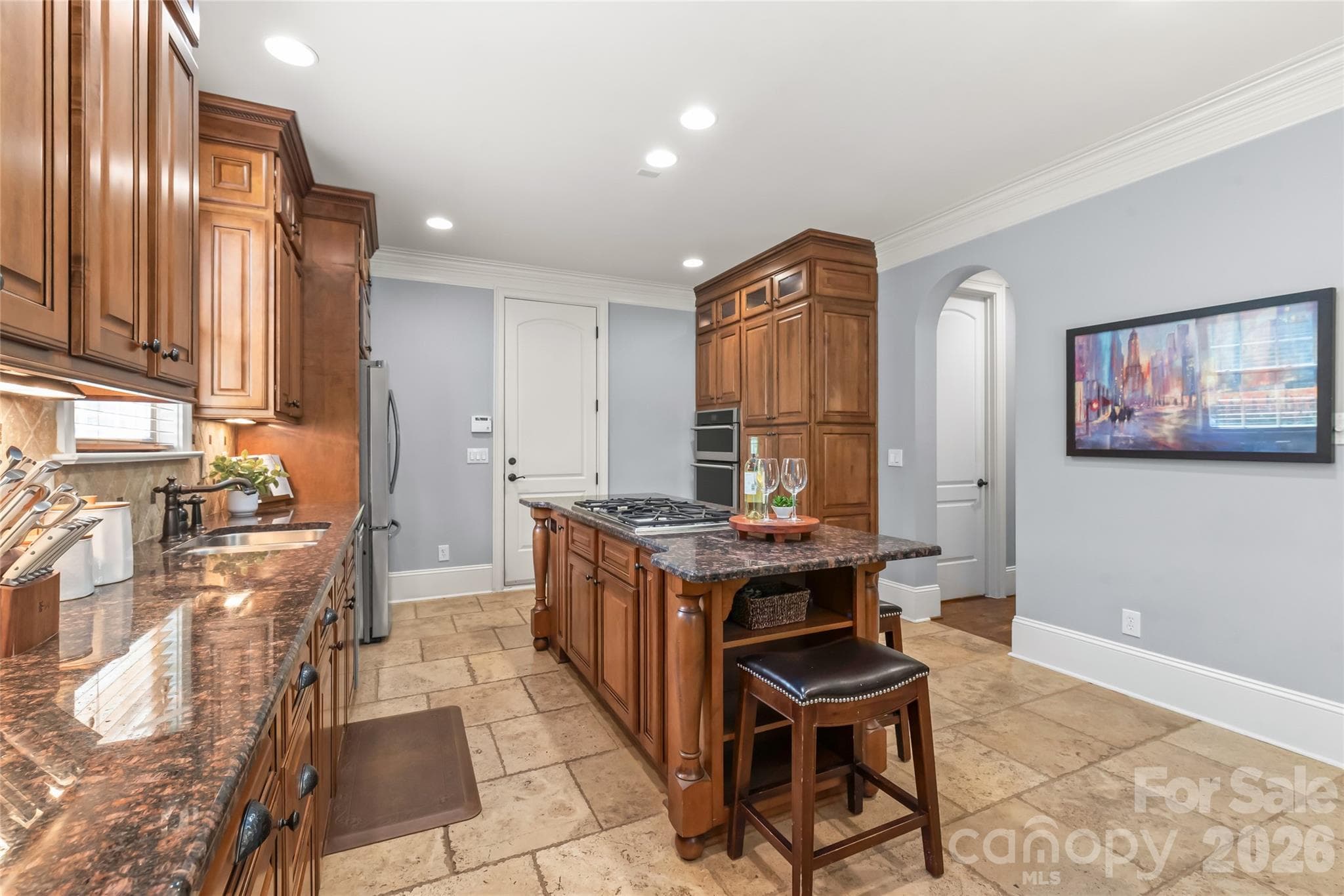 Recessed lighting throughout the kitchen illuminates the workspace while keeping the clean lines of the ceiling uncluttered. - 7320 Summerlin Place, Charlotte
