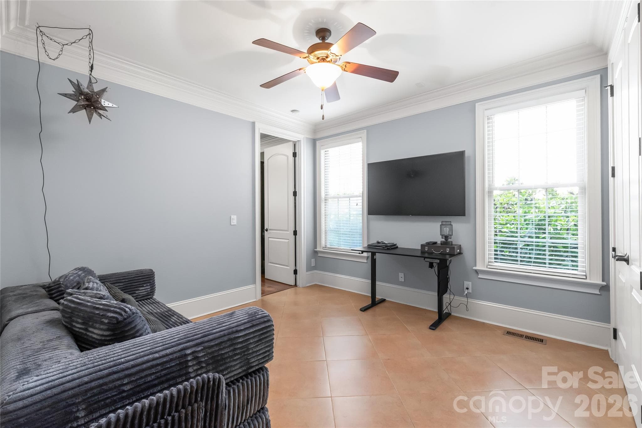 A private main-level fifth bedroom suite offers flexible accommodations with direct access to a full bath...perfect for an in-law retreat, home office, or playroom. - 7320 Summerlin Place, Charlotte