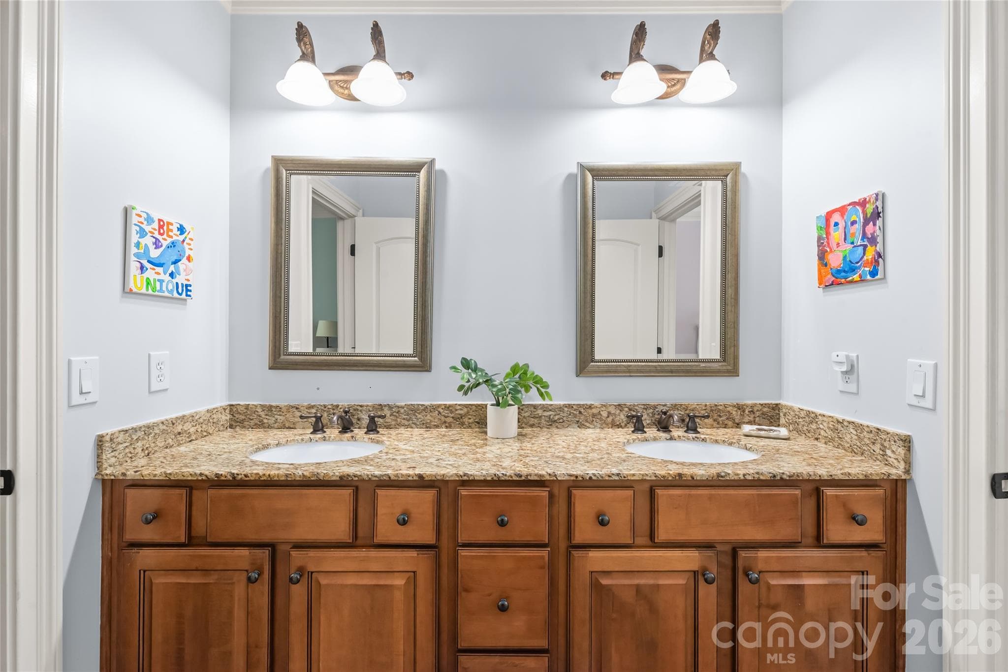 A shared Jack-and-Jill bath connects Bedrooms two and three, featuring a private wet area that separates the tub/shower, and toilet for extra convenience. - 7320 Summerlin Place, Charlotte