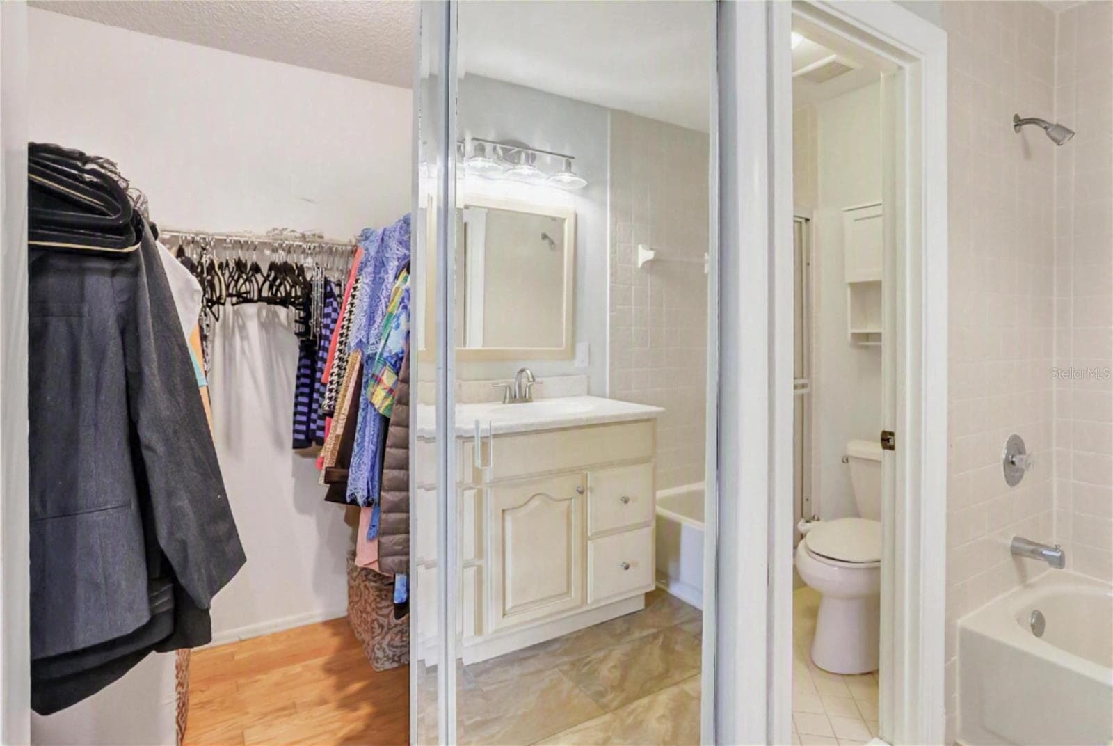 Primary walk in closet and separate room with walk-in shower. - 605 CHESTNUT OAK CIR #107, ALTAMONTE SPRINGS