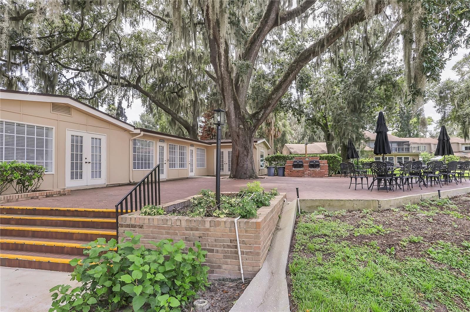 Spacious patio at the clubhouse with BBQ grills and overlooking the pool. - 605 CHESTNUT OAK CIR #107, ALTAMONTE SPRINGS