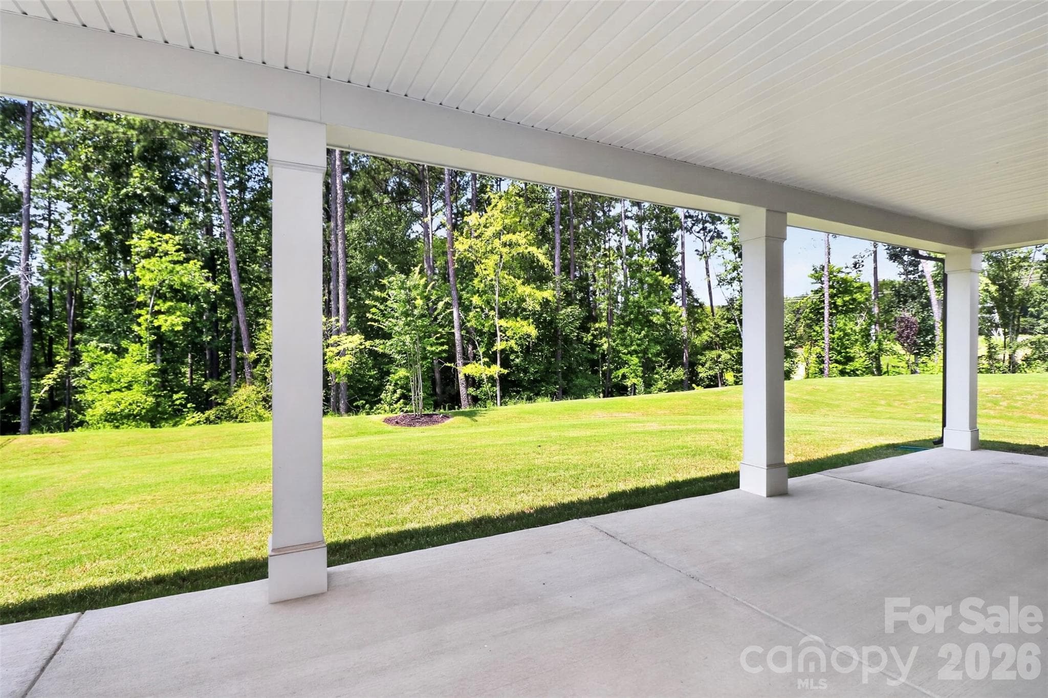 Rear covered patio faceing tree lined backyard - 235 Supernova Drive, York