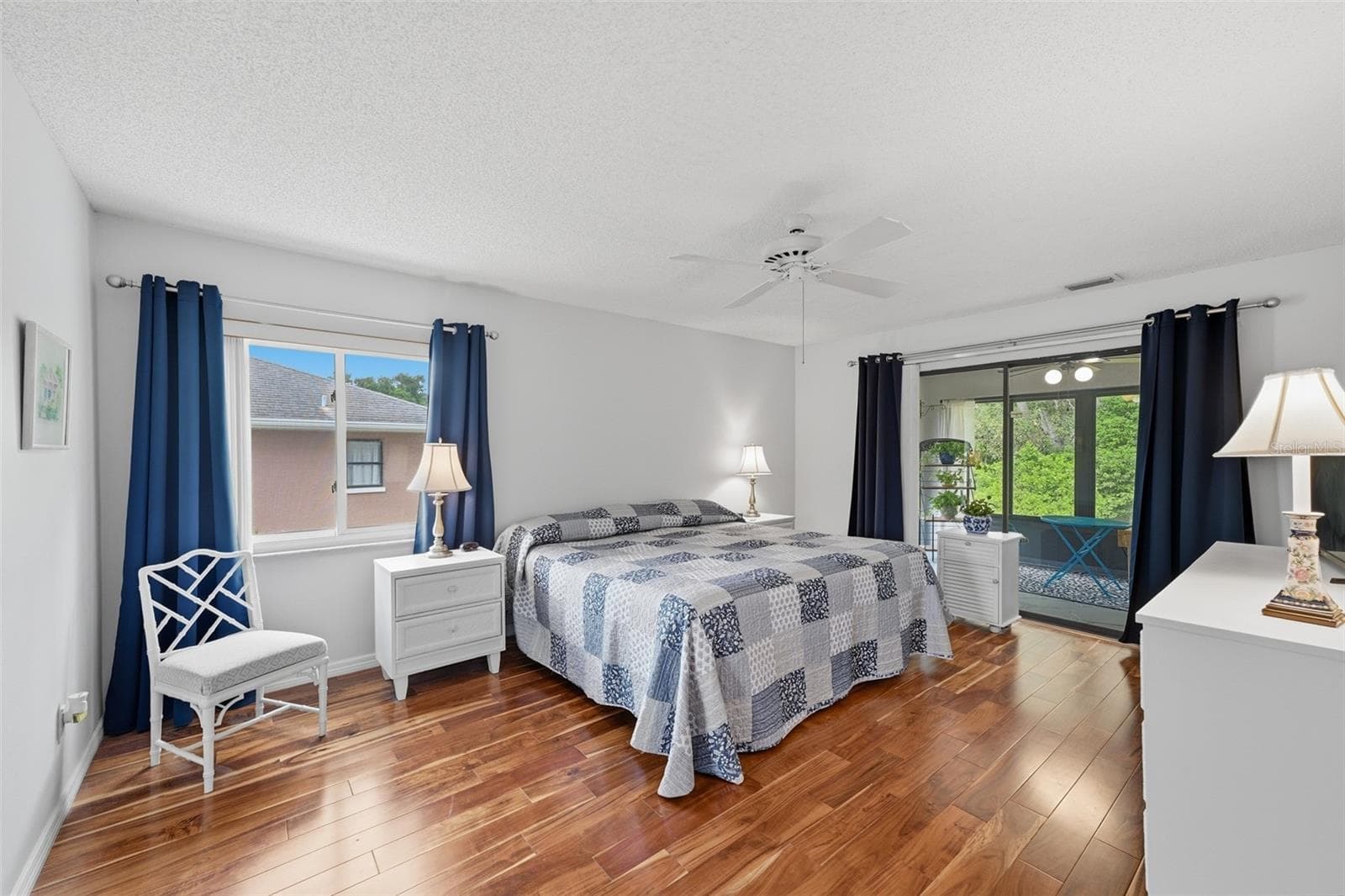ENJOY THE WOODS VIEW FROM YOUR MAIN BEDROOM. NEWER ENGINEERED WOOD FLOORING AND WINDOWS. - 1803 NEW BEDFORD DR, SUN CITY CENTER