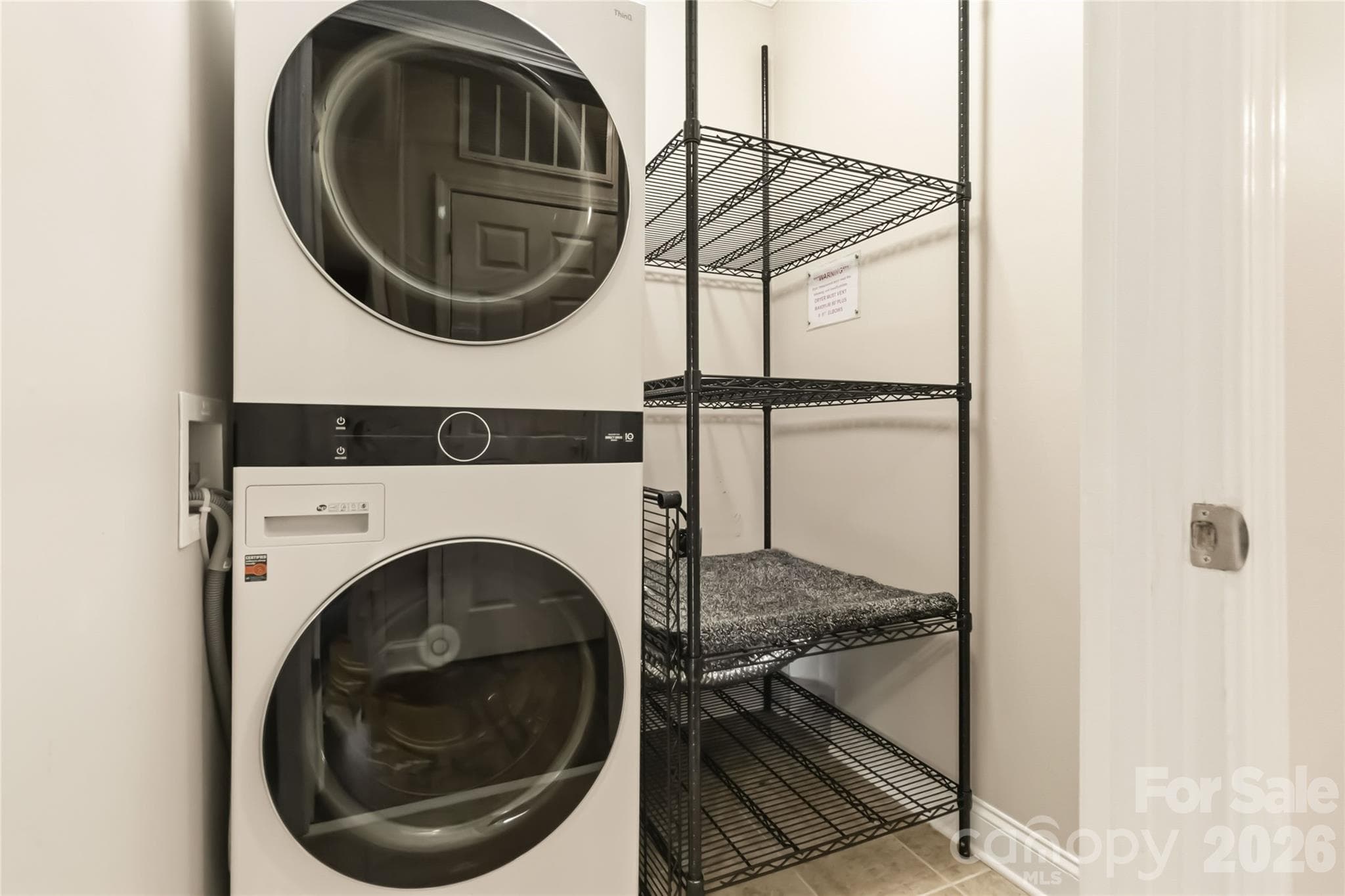 Front-loading washer dryer unit and shelving to convey at closing - 1000 E Woodlawn Road, Charlotte
