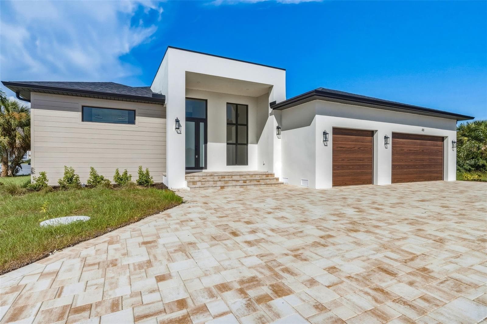 Striking Modern Exterior with Extended Paver Driveway & 3 Car Garage - 44 SUNFLOWER DR, PLACIDA