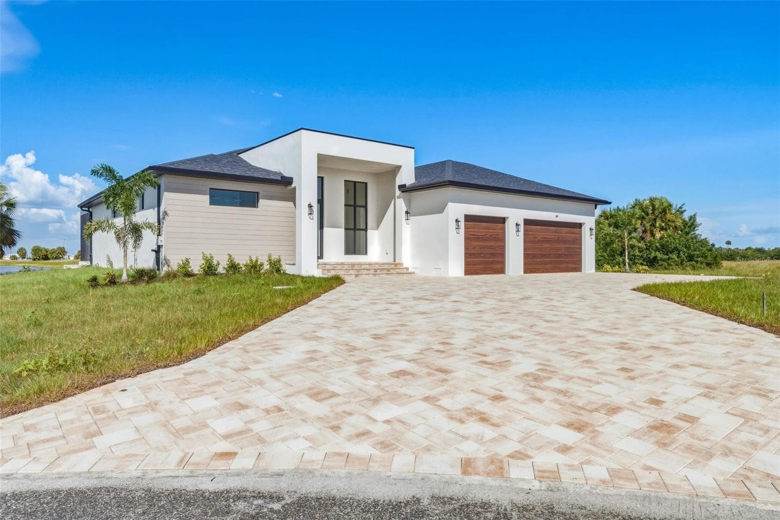 Striking Modern Exterior with Extended Paver Driveway & 3 Car Garage - 44 SUNFLOWER DR, PLACIDA