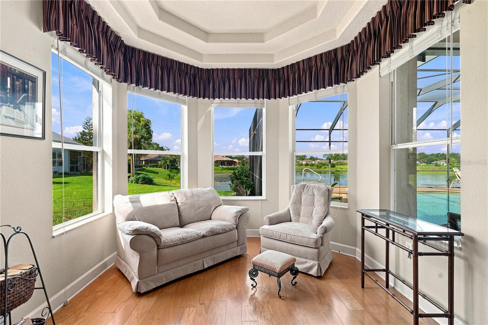 Sitting area in primary bedroom with water view - 9271 WESTSHORE DR, WEEKI WACHEE