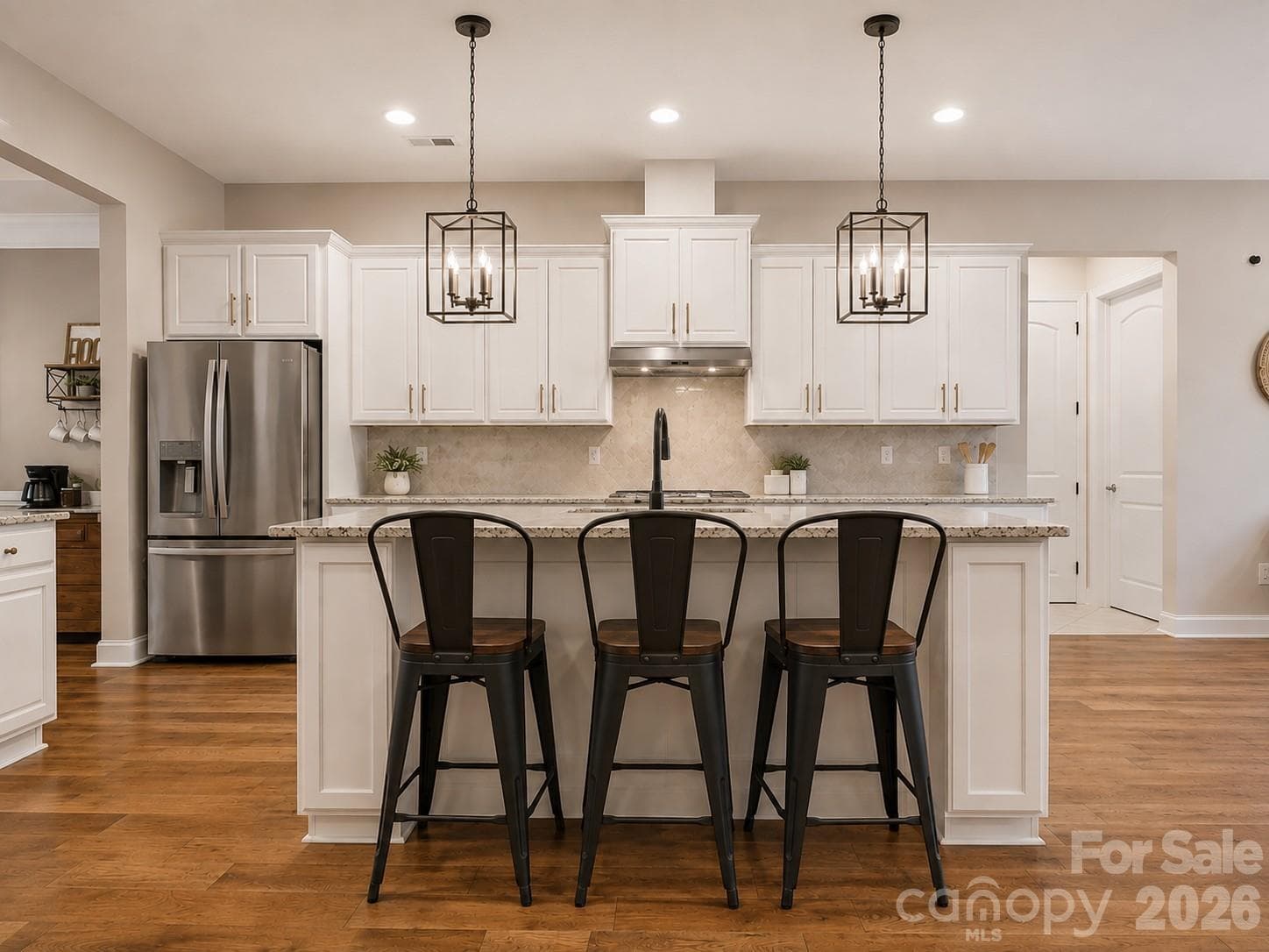 Virtually enhanced to illustrate potential updates to the island color, lighting, cabinet hardware, and plumbing fixture - 968 Rock Forest Way, Indian Land