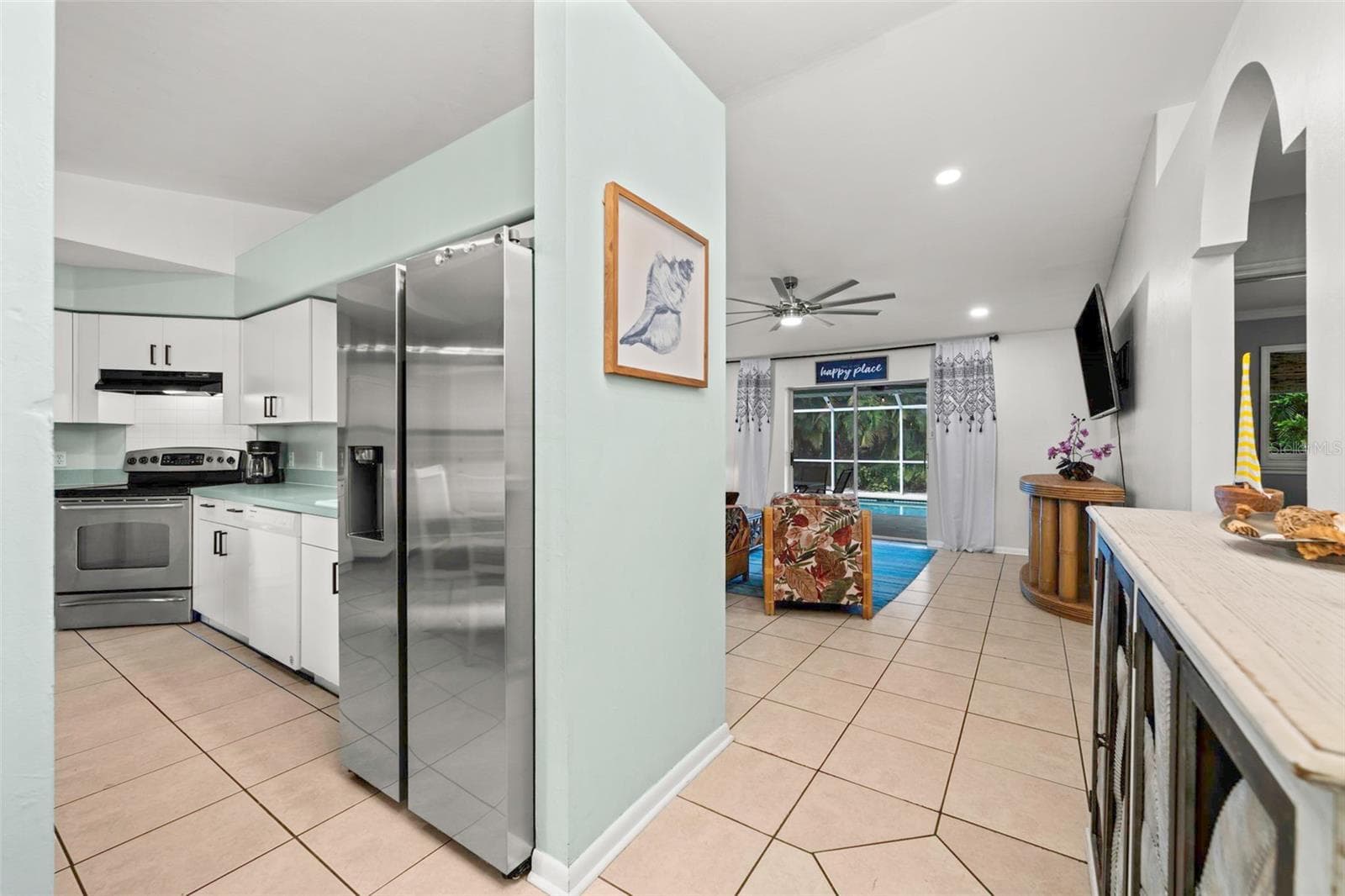 View from the front door to the kitchen and the pool area - 3112 SW 16TH PL, CAPE CORAL