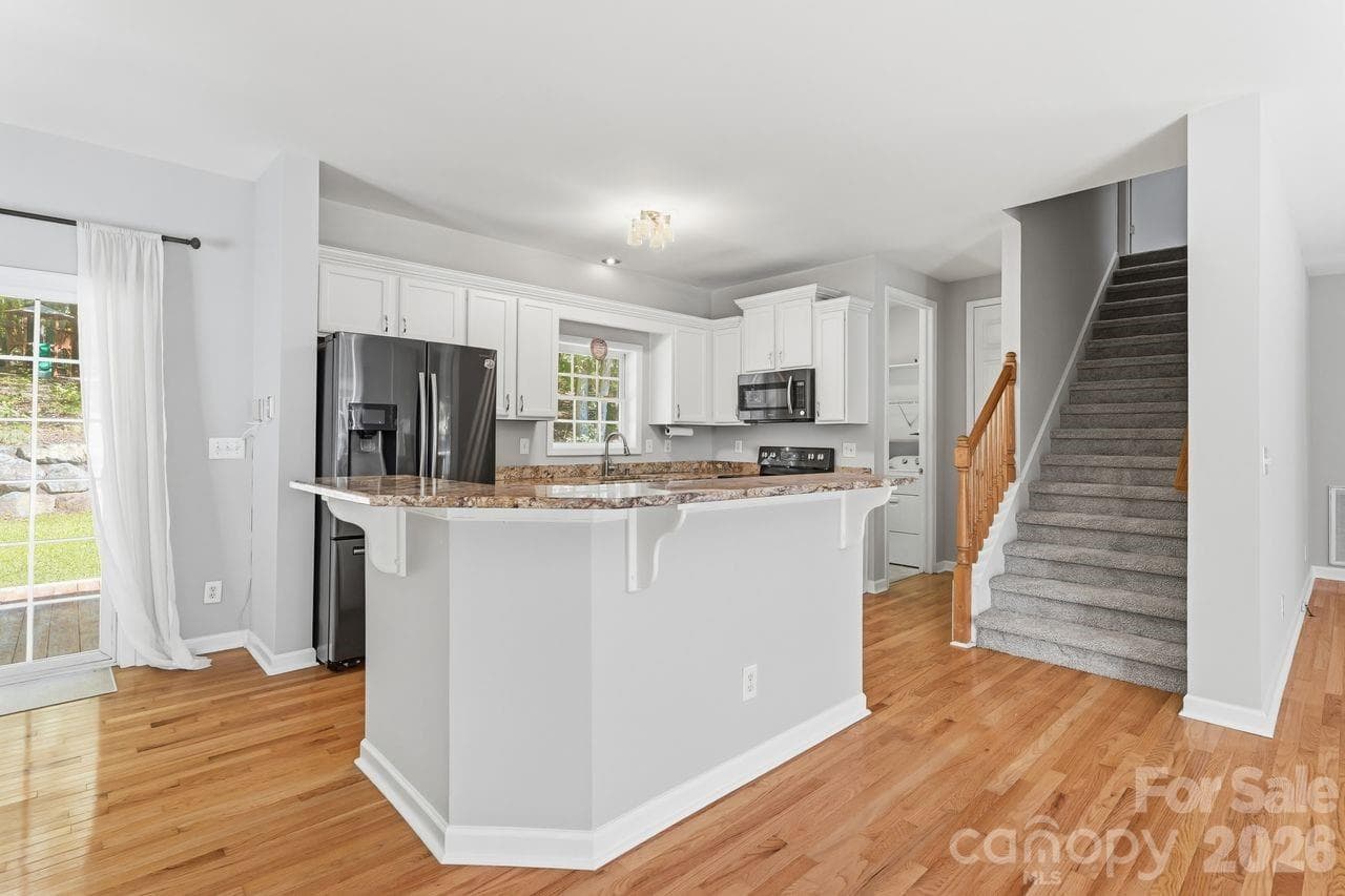 Kitchen with granite tops and black stainless steel appliances - 5480 Liberty Hill Road W, York