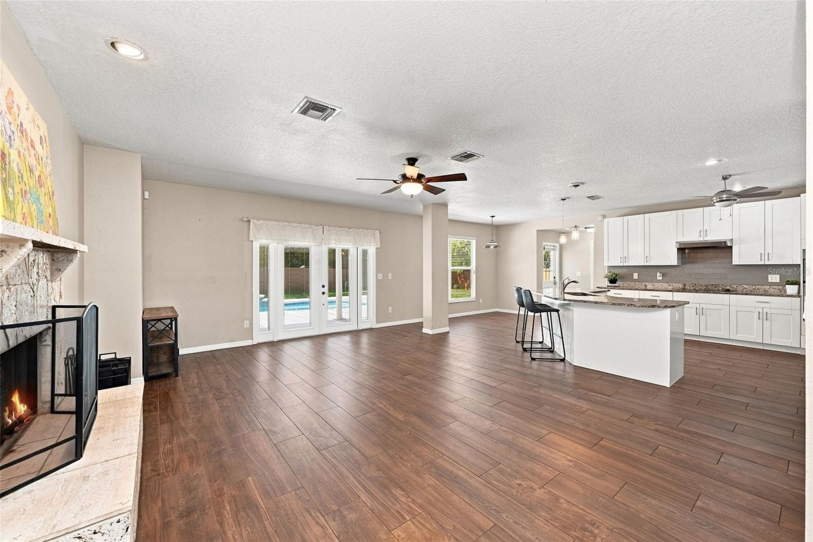 Open Floor Plan with Kitchen & Family Room offers easy entertaining and everyday living with direct views toward the private pool. - 1349 VALLEY PINE CIR, APOPKA