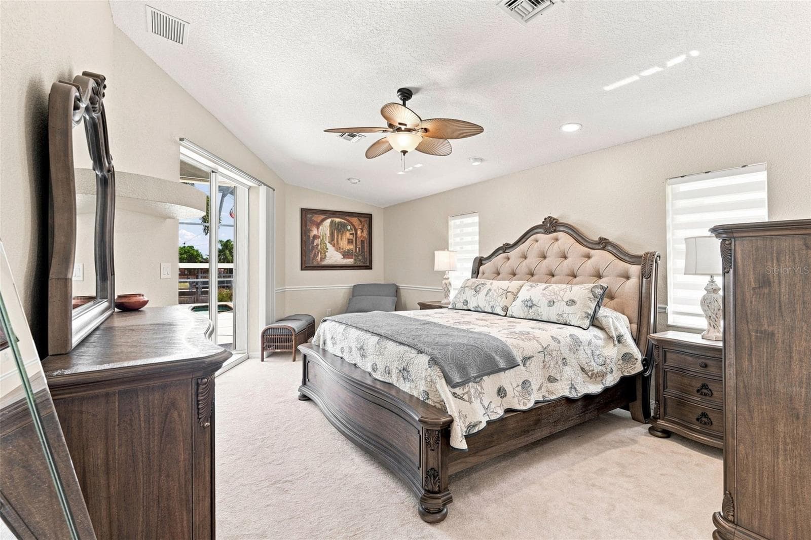 Relaxing Primary Suite with Ceiling Fan and Sliding Doors to Pool - 136 PECKHAM ST SE, PORT CHARLOTTE