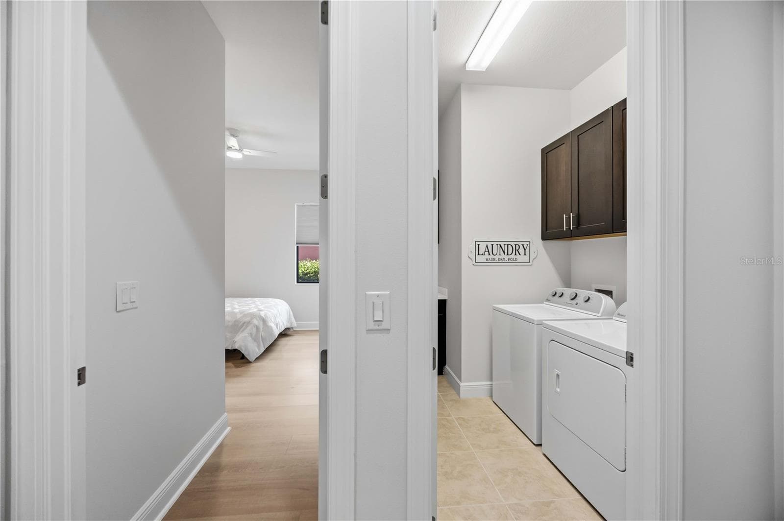 The laundry area has a utility sink and washer /dryer. - 23781 WAVERLY CIR, VENICE
