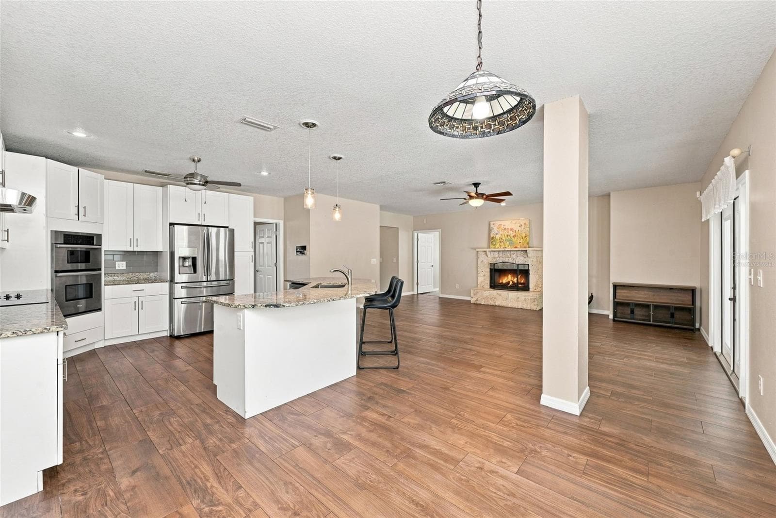 Casual Dining Area provides a bright and comfortable space for everyday meals with views toward the kitchen, family room, and pool. - 1349 VALLEY PINE CIR, APOPKA