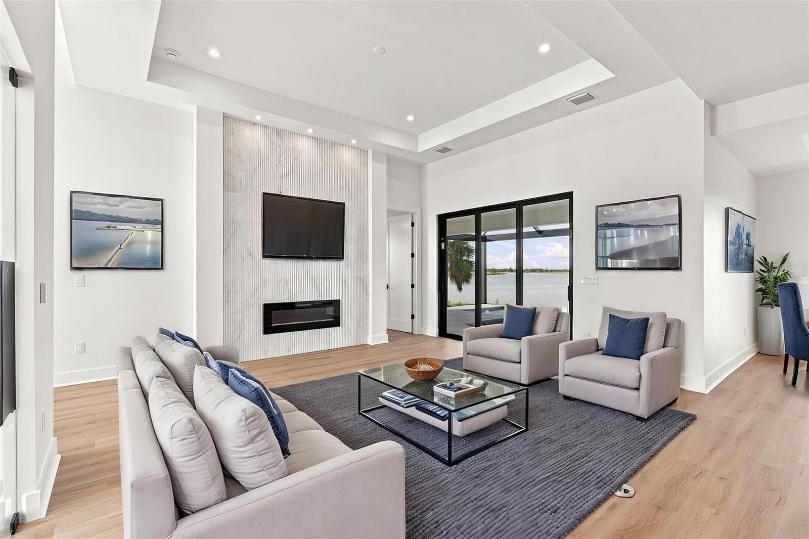 Virtually Staged Living Room with Tray Ceiling & Modern Fireplace Media Wall - 44 SUNFLOWER DR, PLACIDA