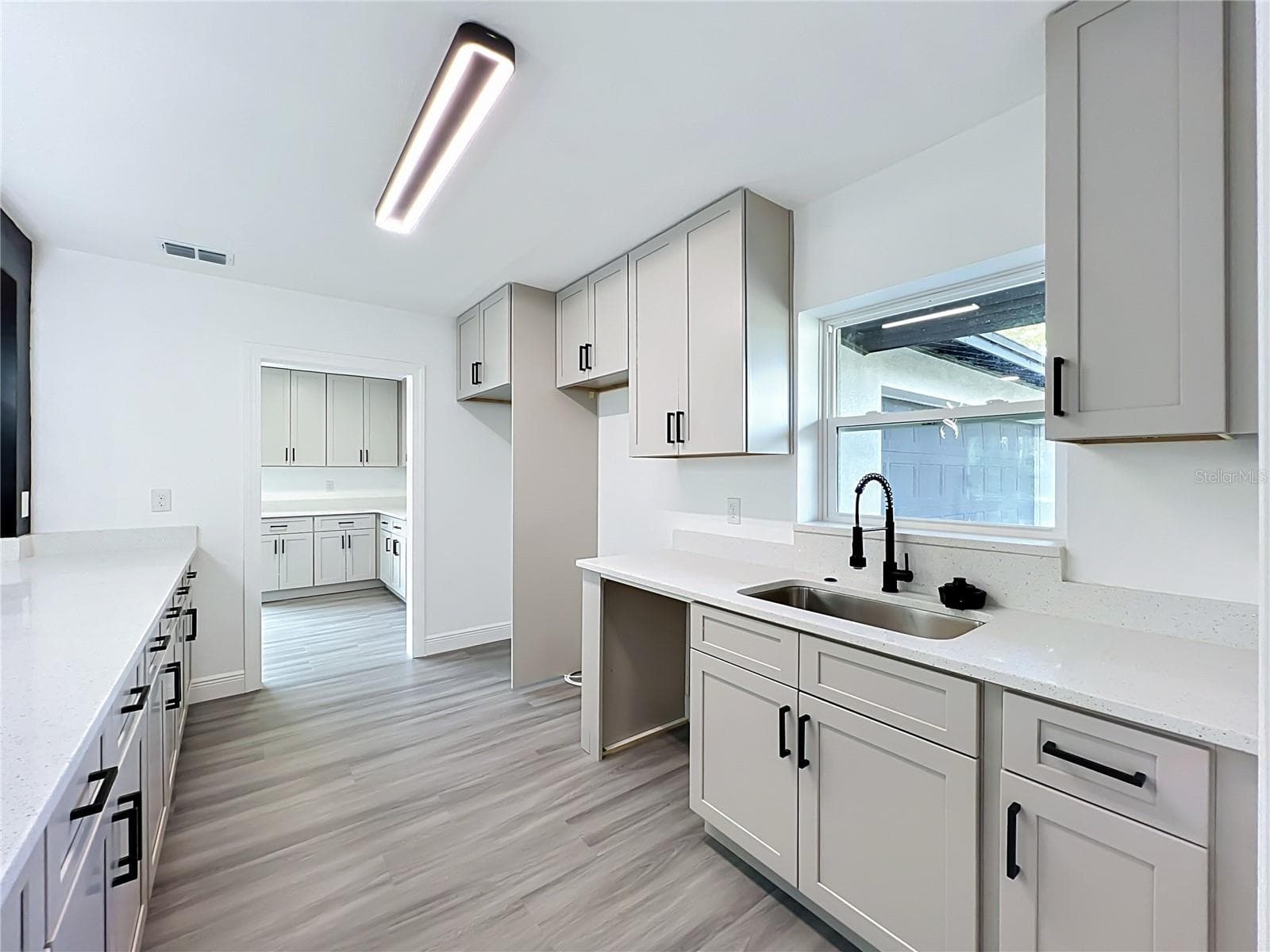 A bright kitchen with plenty of workspace for cooking, entertaining and everyday life. - 3202 TRADEWINDS TRL, ORLANDO