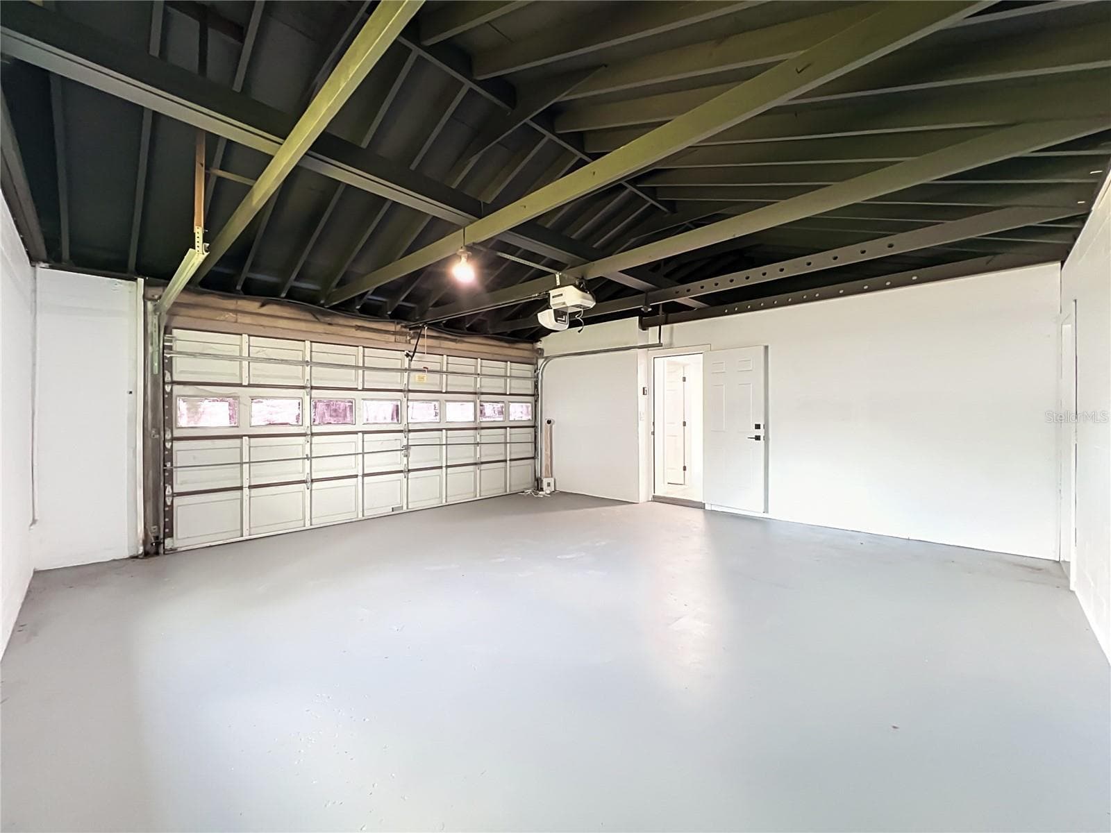 Attached garage provides valuable parking, storage and everyday convenience. - 3202 TRADEWINDS TRL, ORLANDO
