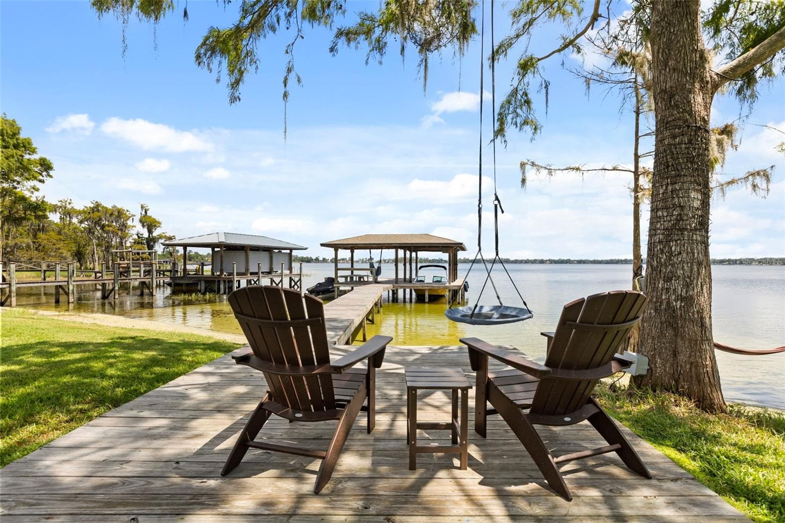 A private dock and boatlift provide immediate access to Lake Sheen and the entire Butler Chain, while a gated community boat ramp is approximately 300 feet away. - 10430 LAKE COTTAGE LN, ORLANDO