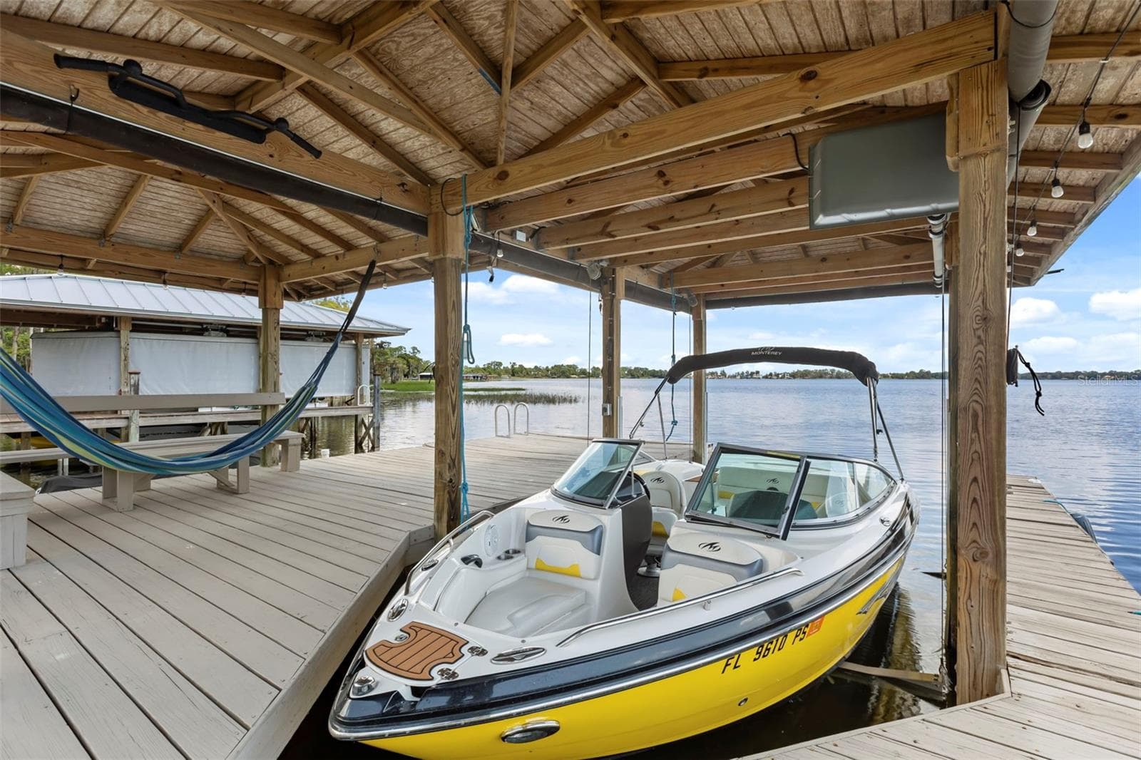 A private dock and boatlift provide immediate access to Lake Sheen and the entire Butler Chain, while a gated community boat ramp is approximately 300 feet away. - 10430 LAKE COTTAGE LN, ORLANDO