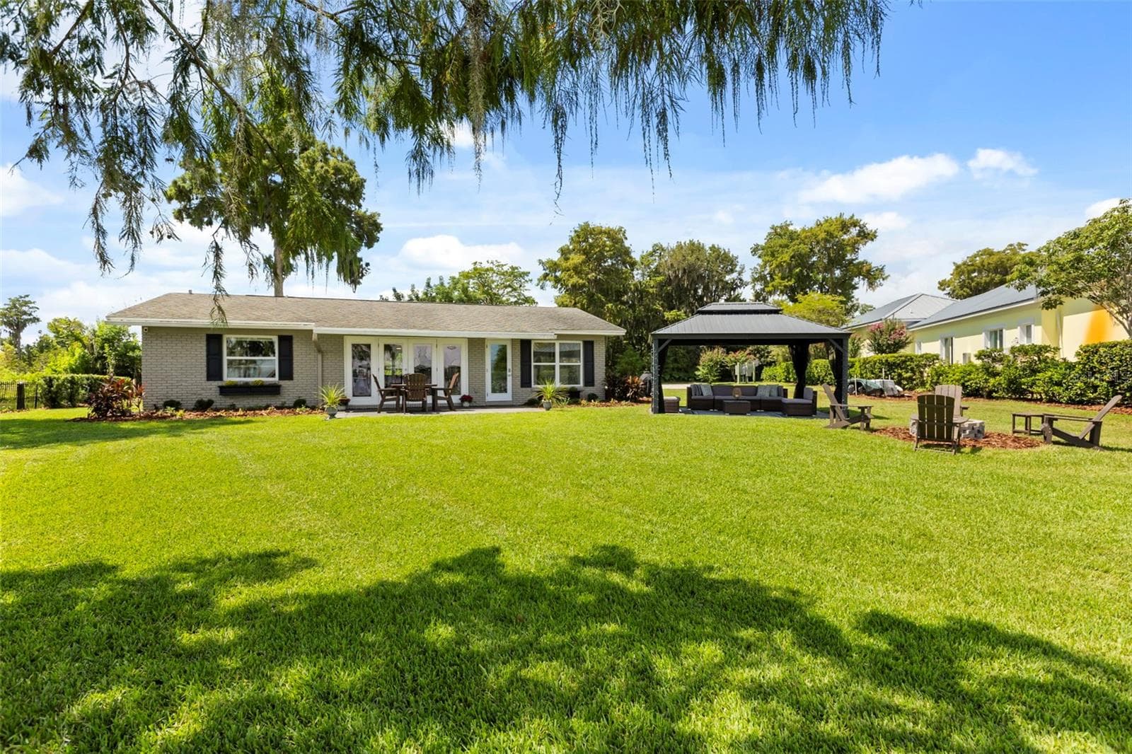 Lake Cottage Lane, featuring an oversized homesite, expansive Lake Sheen views, sandy shoreline, private dock and boatlift, and an existing 2BR/1.5BA lake cottage that can be enjoyed today while you plan the lakefront estate of your dreams. - 10430 LAKE COTTAGE LN, ORLANDO