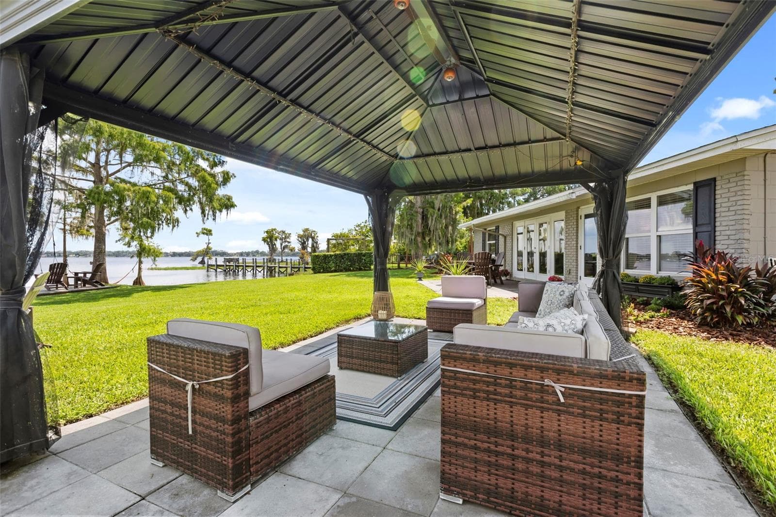 Lake Cottage Lane, featuring an oversized homesite, expansive Lake Sheen views, sandy shoreline, private dock and boatlift, and an existing 2BR/1.5BA lake cottage that can be enjoyed today while you plan the lakefront estate of your dreams. - 10430 LAKE COTTAGE LN, ORLANDO