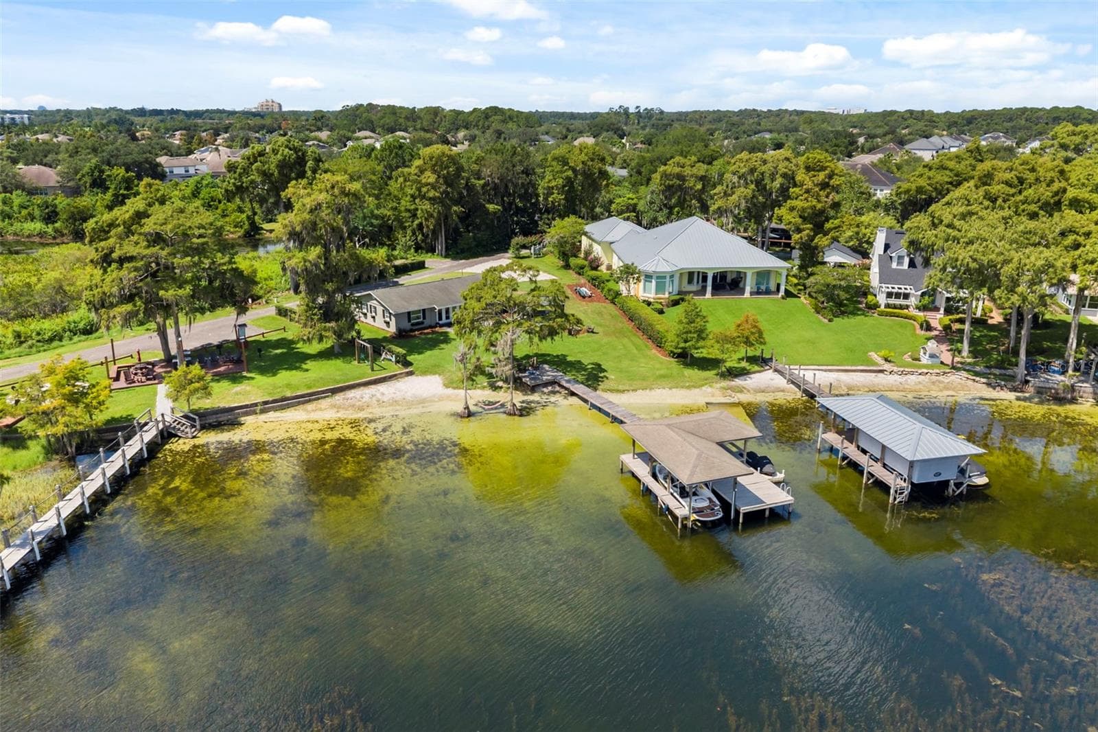 An exceptional opportunity to own one of the most compelling lakefront properties on Lake Cottage Lane, featuring an oversized homesite, expansive Lake Sheen views, sandy shoreline, private dock and boatlift, and an existing 2BR/1.5BA lake cottage that can be enjoyed today while you plan the lakefront estate of your dreams. - 10430 LAKE COTTAGE LN, ORLANDO