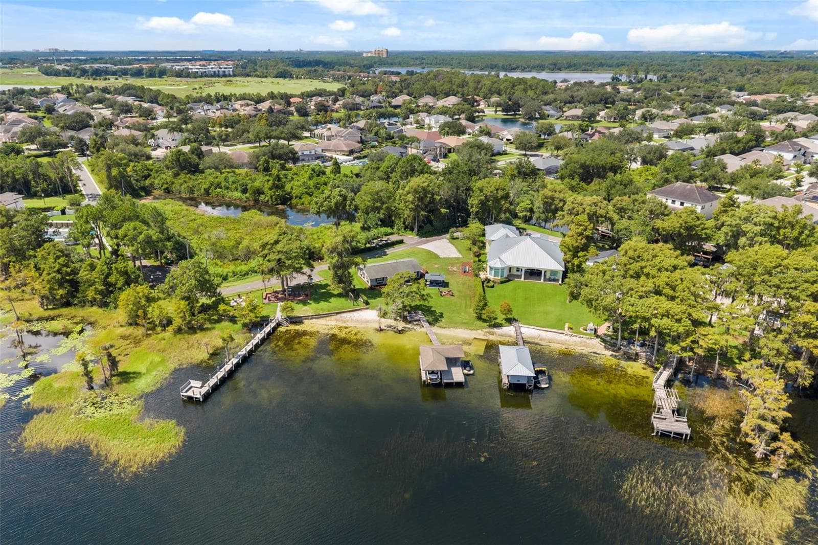 An exceptional opportunity to own one of the most compelling lakefront properties on Lake Cottage Lane, featuring an oversized homesite, expansive Lake Sheen views, sandy shoreline, private dock and boatlift, and an existing 2BR/1.5BA lake cottage that can be enjoyed today while you plan the lakefront estate of your dreams. - 10430 LAKE COTTAGE LN, ORLANDO