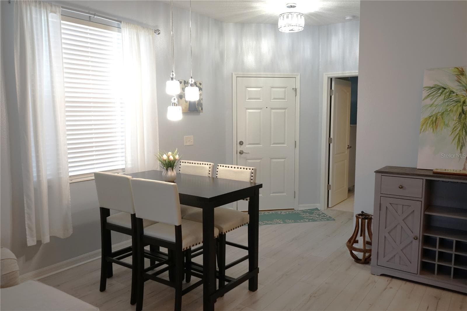 dining and entrance door, primary bedroom is down the hall on the right - 2032 INVERNESS GREENS DR #76, SUN CITY CENTER