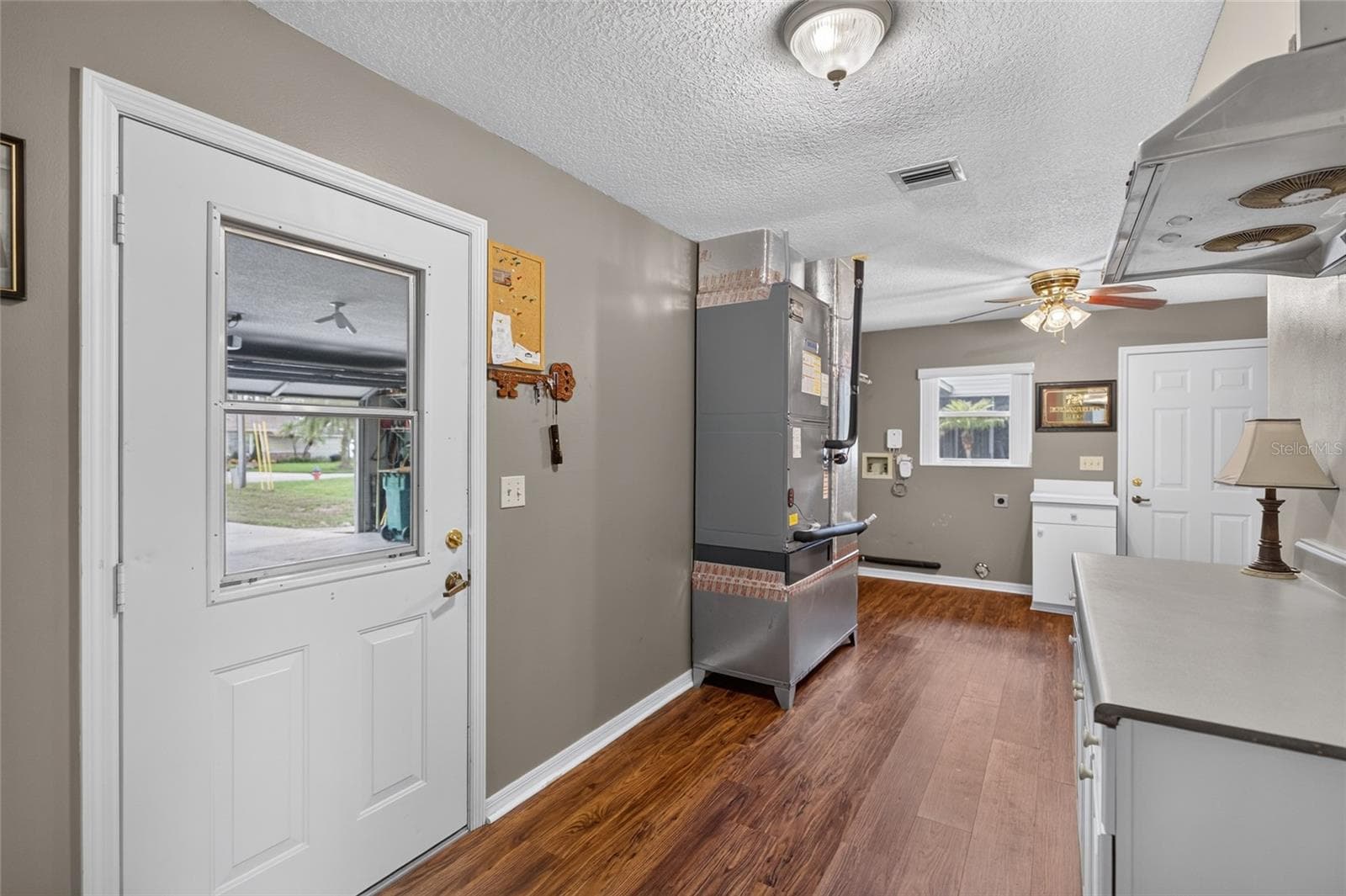 Large laundry room from the garage entrance - 235 TEMPLE CIR, EUSTIS