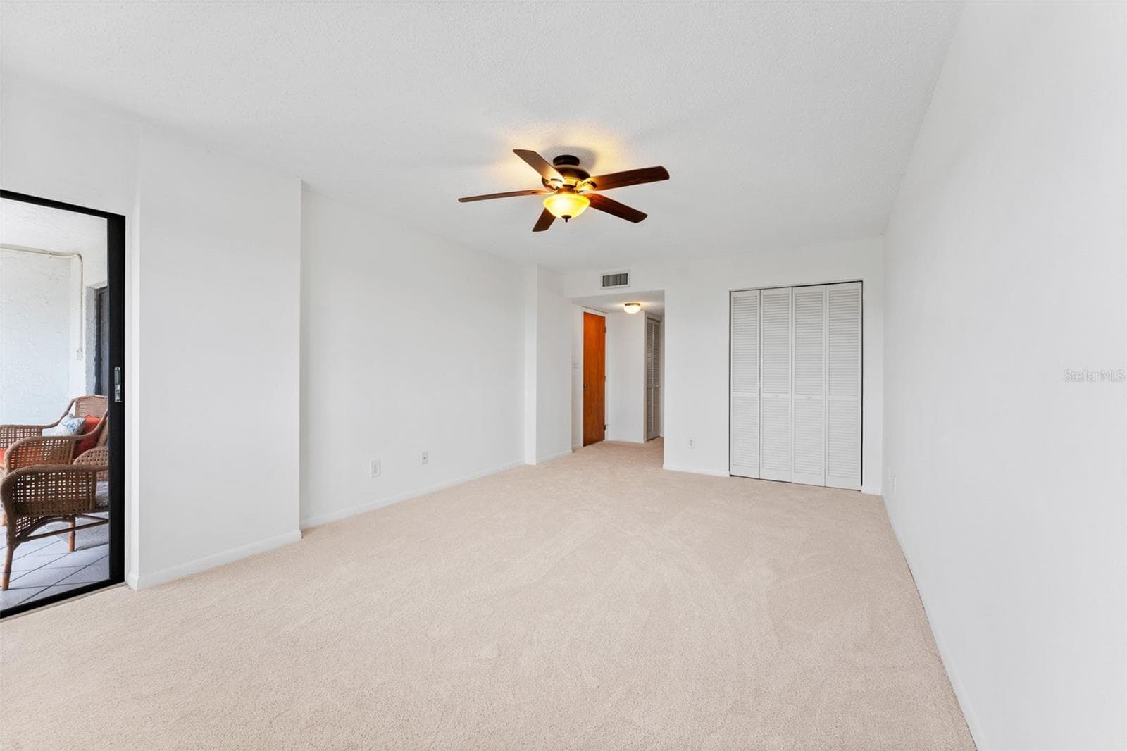 The primary bedroom is oversized, and has loads of closet space. You also have access to your screened lanai from here. - 5400 PARK ST N #511, ST PETERSBURG