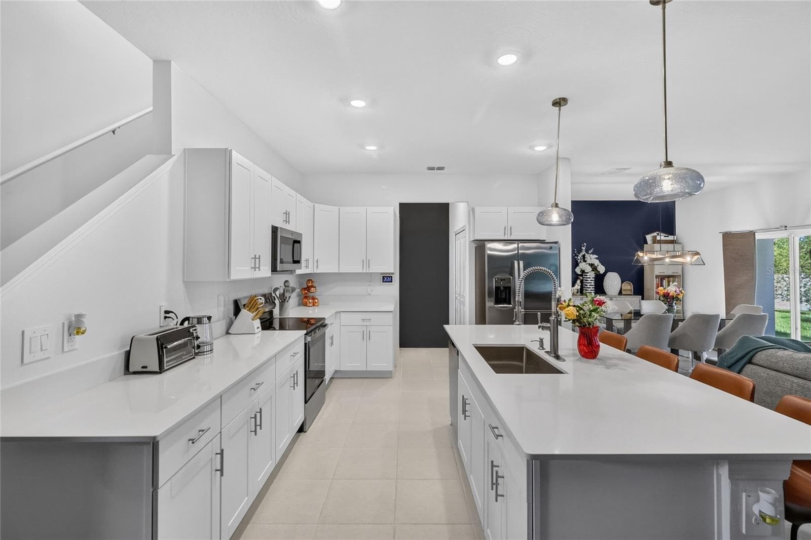 Quartz counter tops and tile floors in the kitchen.  Open concept with large island. - 36227 JOSEPH BLAKE ST, ZEPHYRHILLS