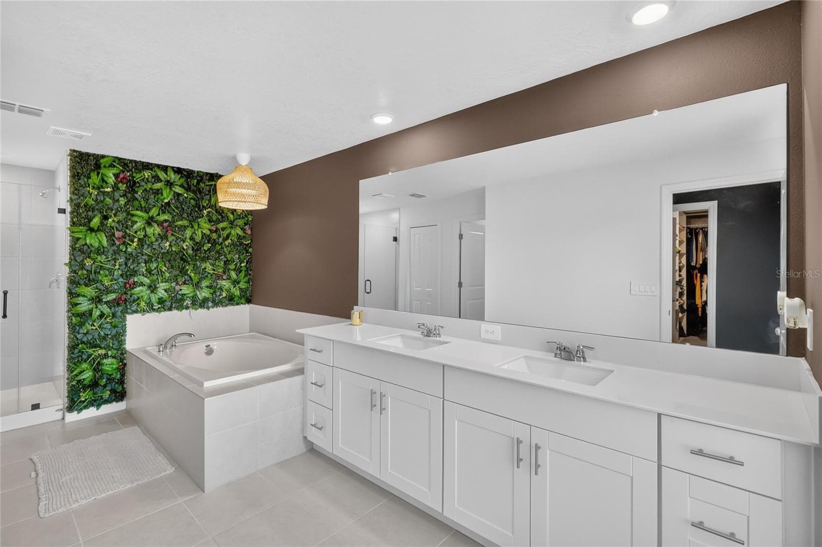 Primary bathroom has two sinks, soaking tub and walk-in shower. - 36227 JOSEPH BLAKE ST, ZEPHYRHILLS
