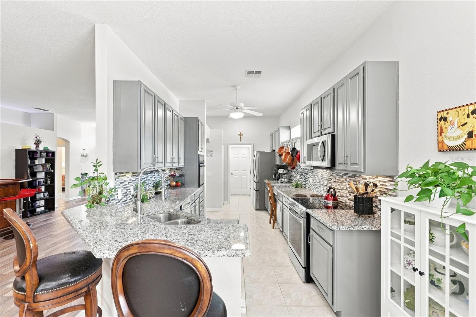 Beautiful Kitchen with Laundry Room at the other end. - 367 FOXHILL DR, DEBARY