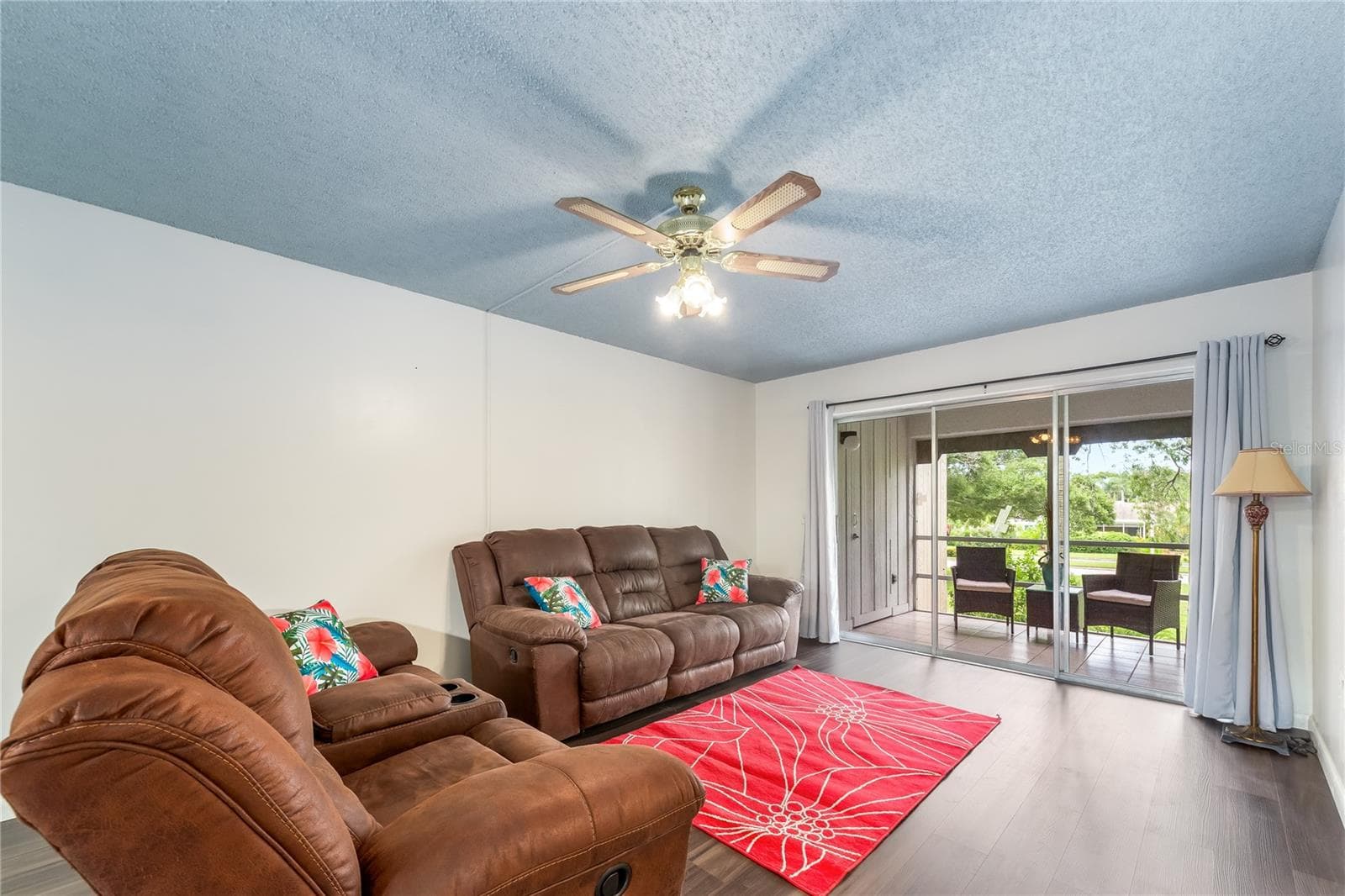 A living room with a view of mature Florida trees - 209 CORDOVA GRN #209, SEMINOLE