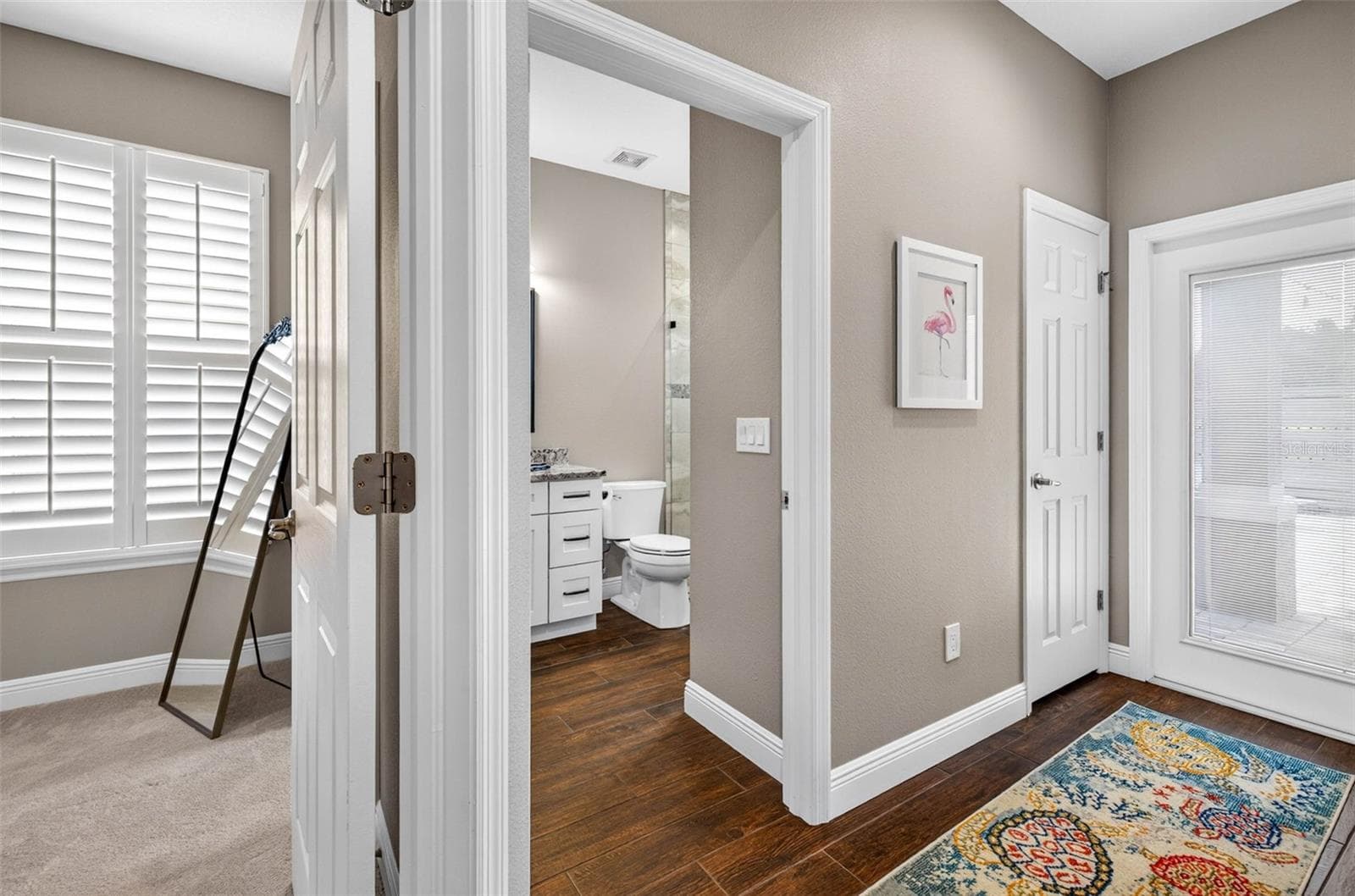 Bedroom 3 with connected bathroom. Door to patio - 4760 LAGO VISTA CIR, LAND O LAKES