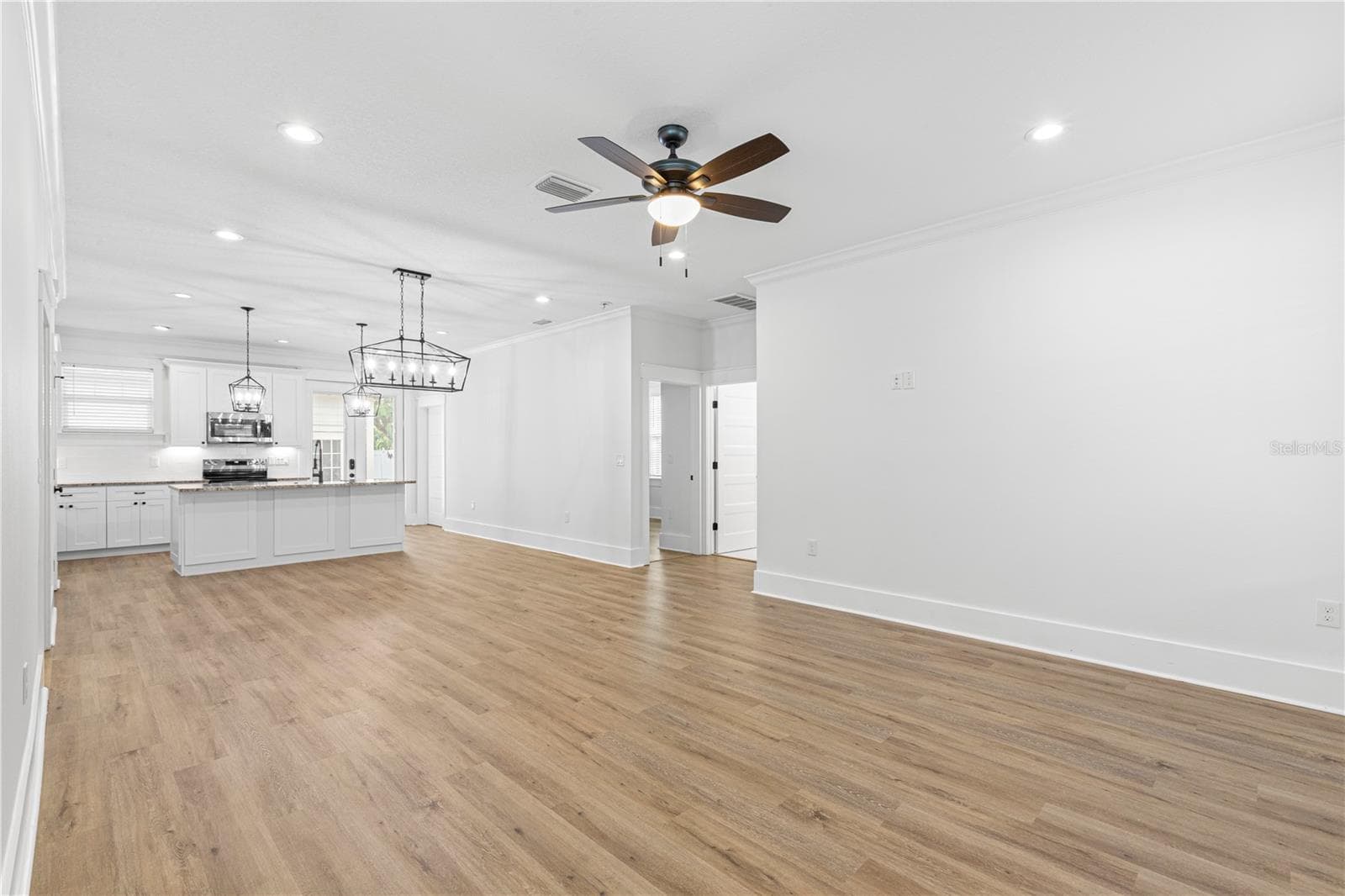 The view as soon as you walk in the front door (Living Room, Dining Room, Kitchen) - 3923 W GRAY ST, TAMPA