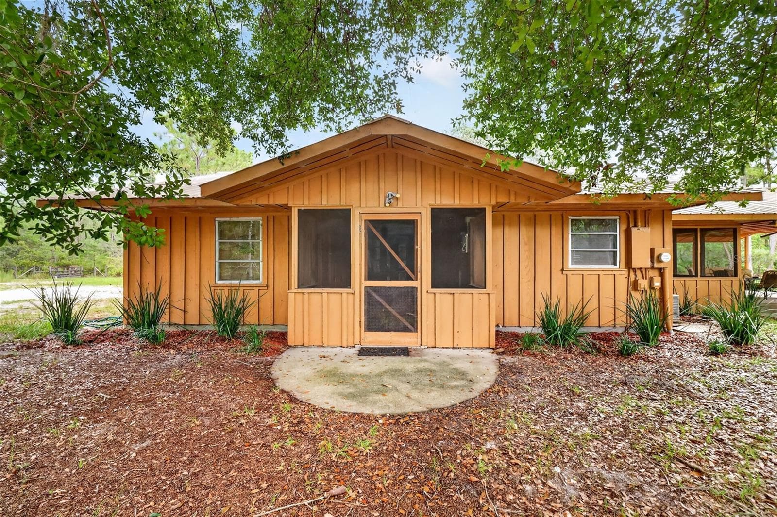 9" x 11' screened side porch with laundry hookups and tankless water heater access, cement landing entry - 24939 OLD DEER RD, PAISLEY
