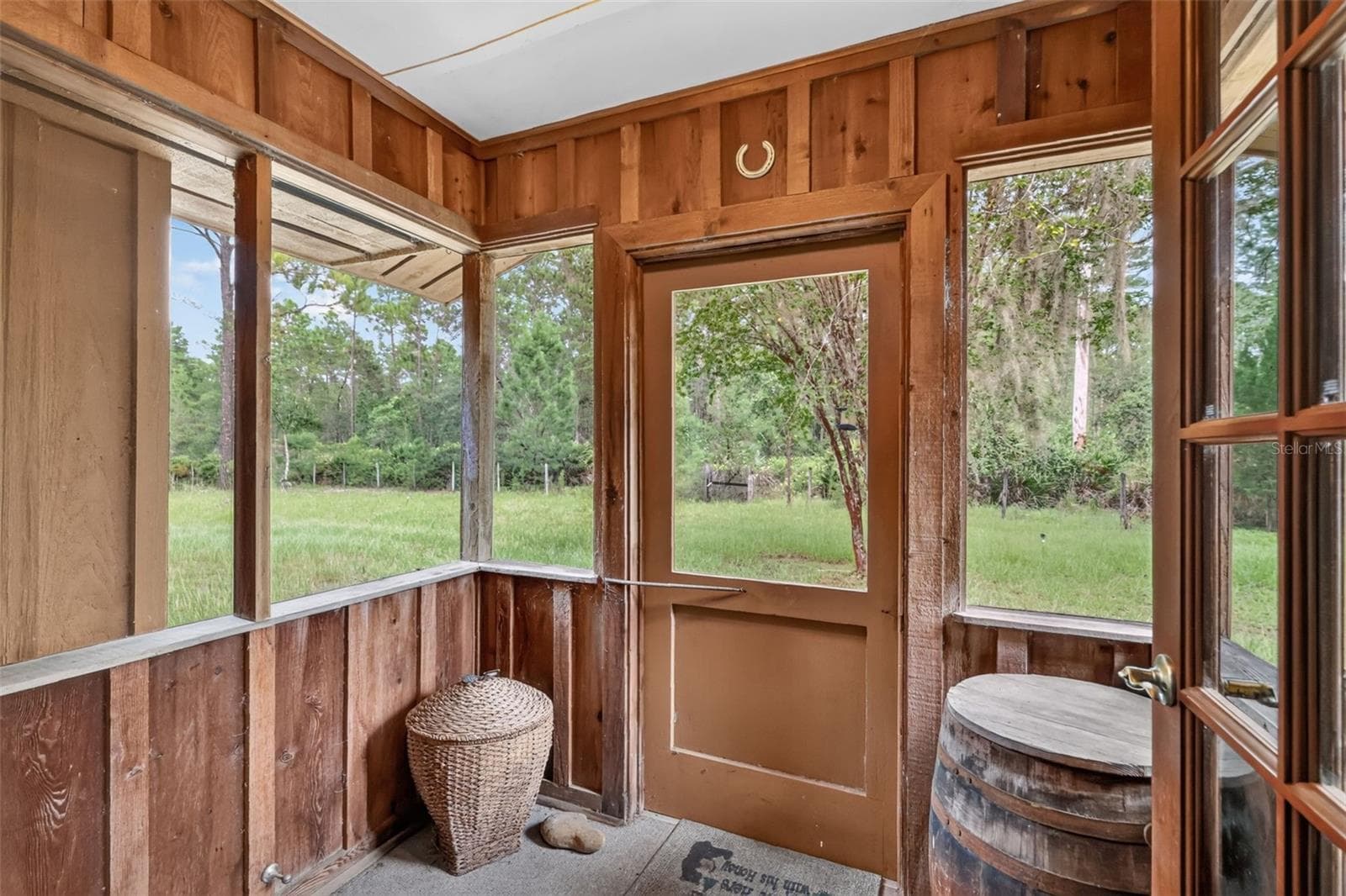 Interior view of 9' x 11' screened porch out to the side yard - 24939 OLD DEER RD, PAISLEY