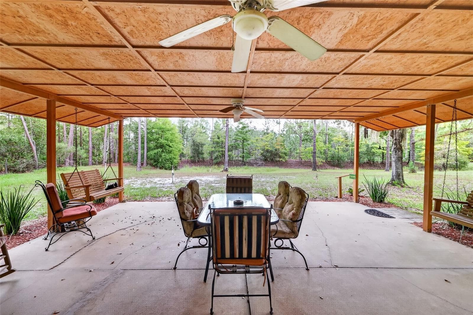 Another long view of porch from the other end out to the yard - 24939 OLD DEER RD, PAISLEY