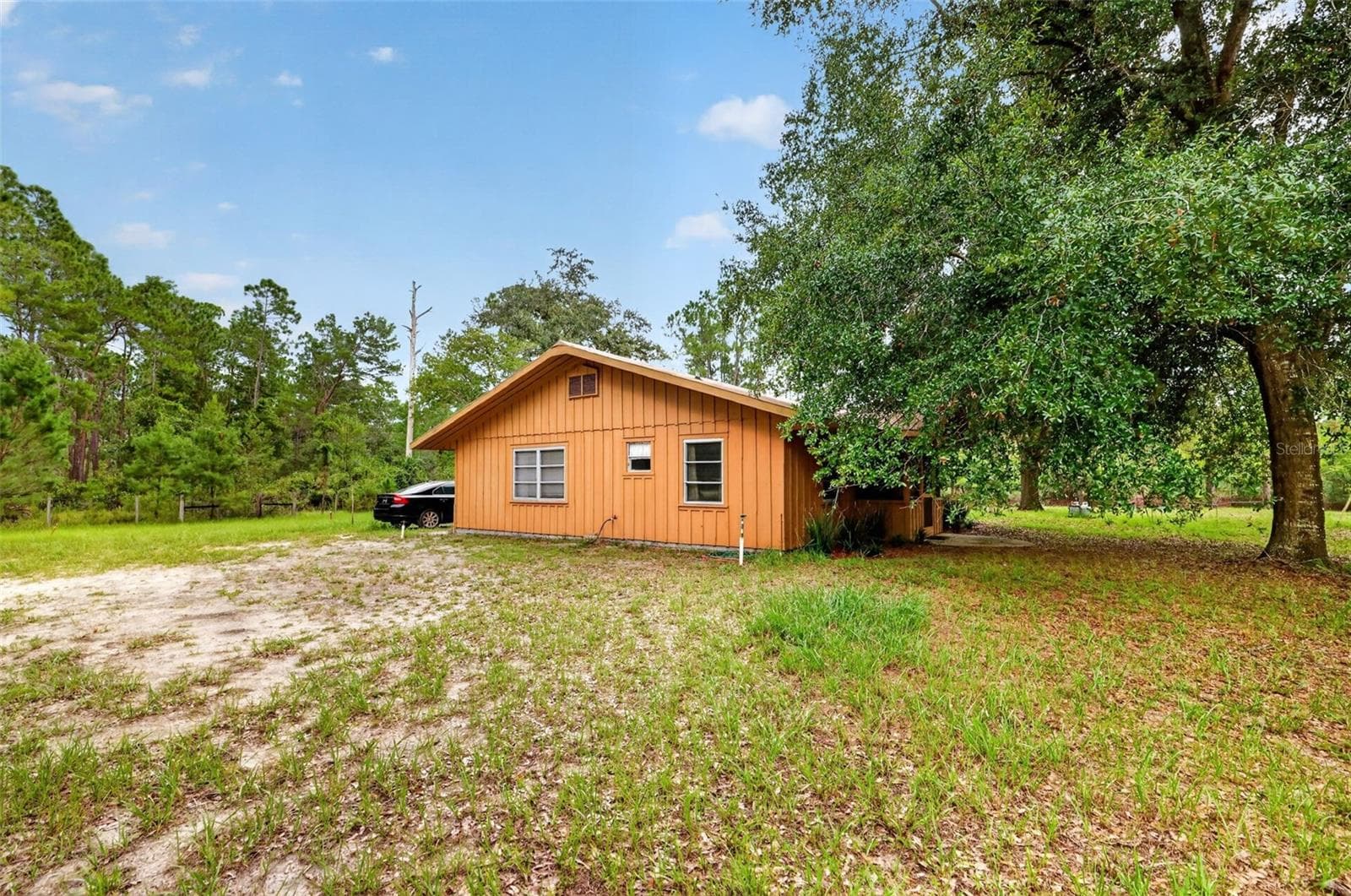View of rear of house from the yard. - 24939 OLD DEER RD, PAISLEY