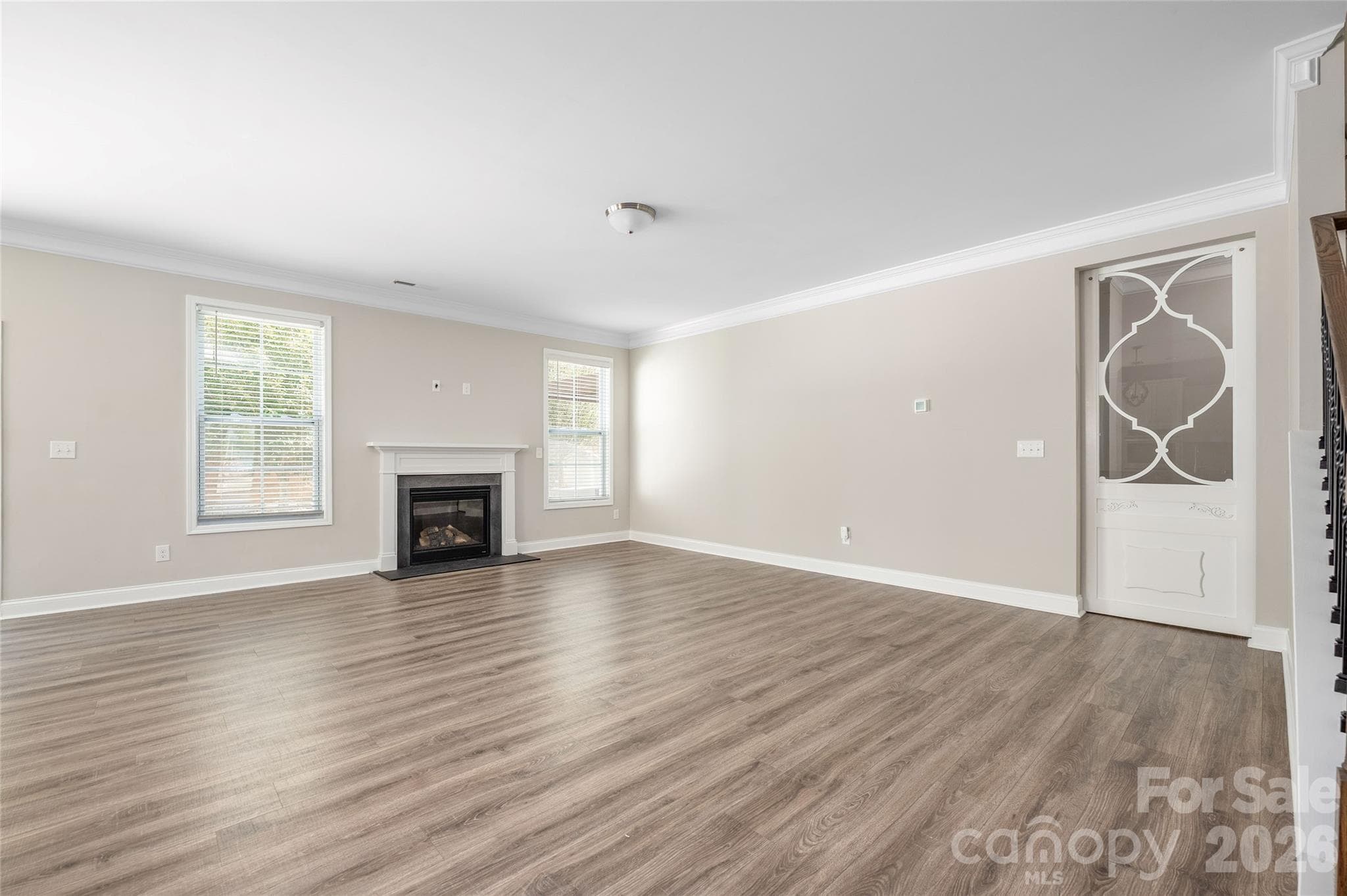 Living room with sliding door to downstairs bedroom closed - 144 Chance Road, Mooresville