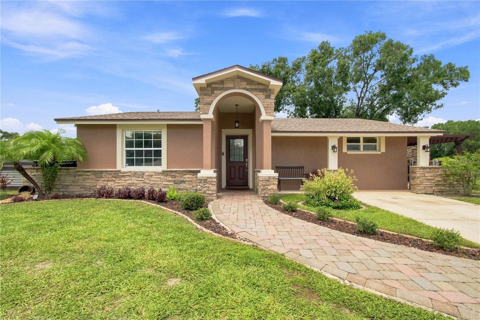 Front View warm color stone decor blends for a cohesive upgrade look, with Portico and Porch, paved walkway to complete the beautiful curb appeal. - 9020 AUBURN WAY, TAMPA