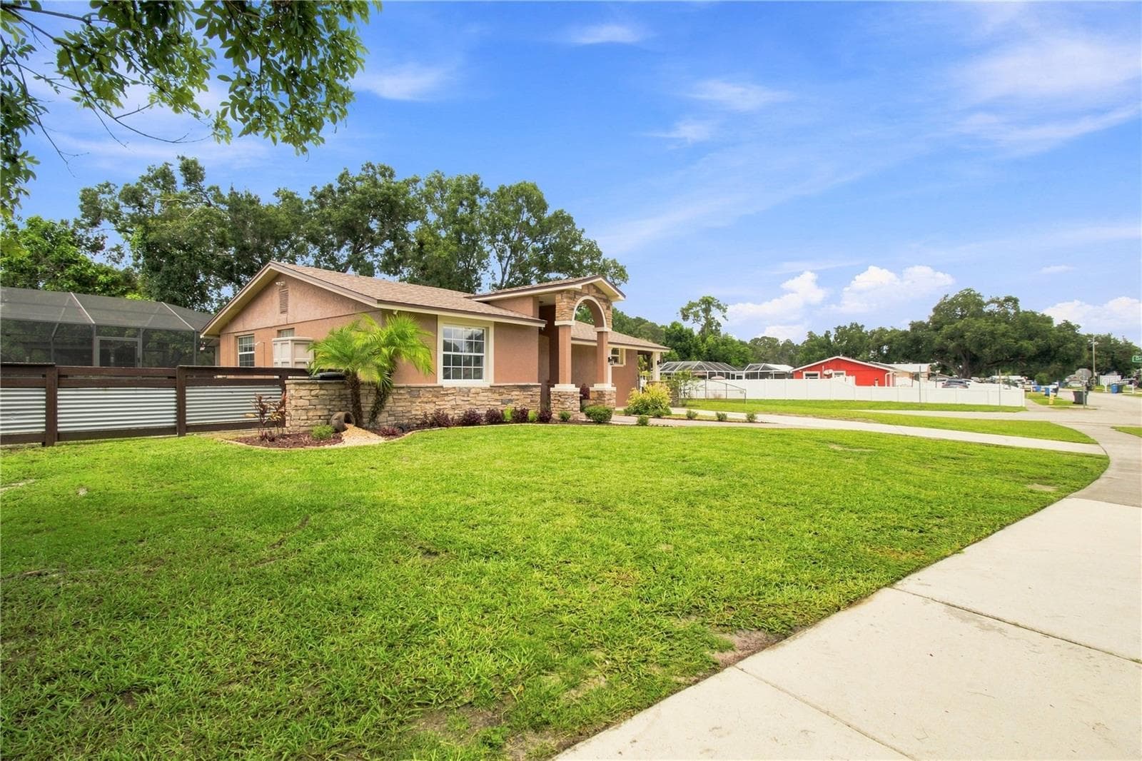 Front View warm color stone decor blends for a cohesive upgrade look, with Portico and Porch, paved walkway to complete the beautiful curb appeal. - 9020 AUBURN WAY, TAMPA